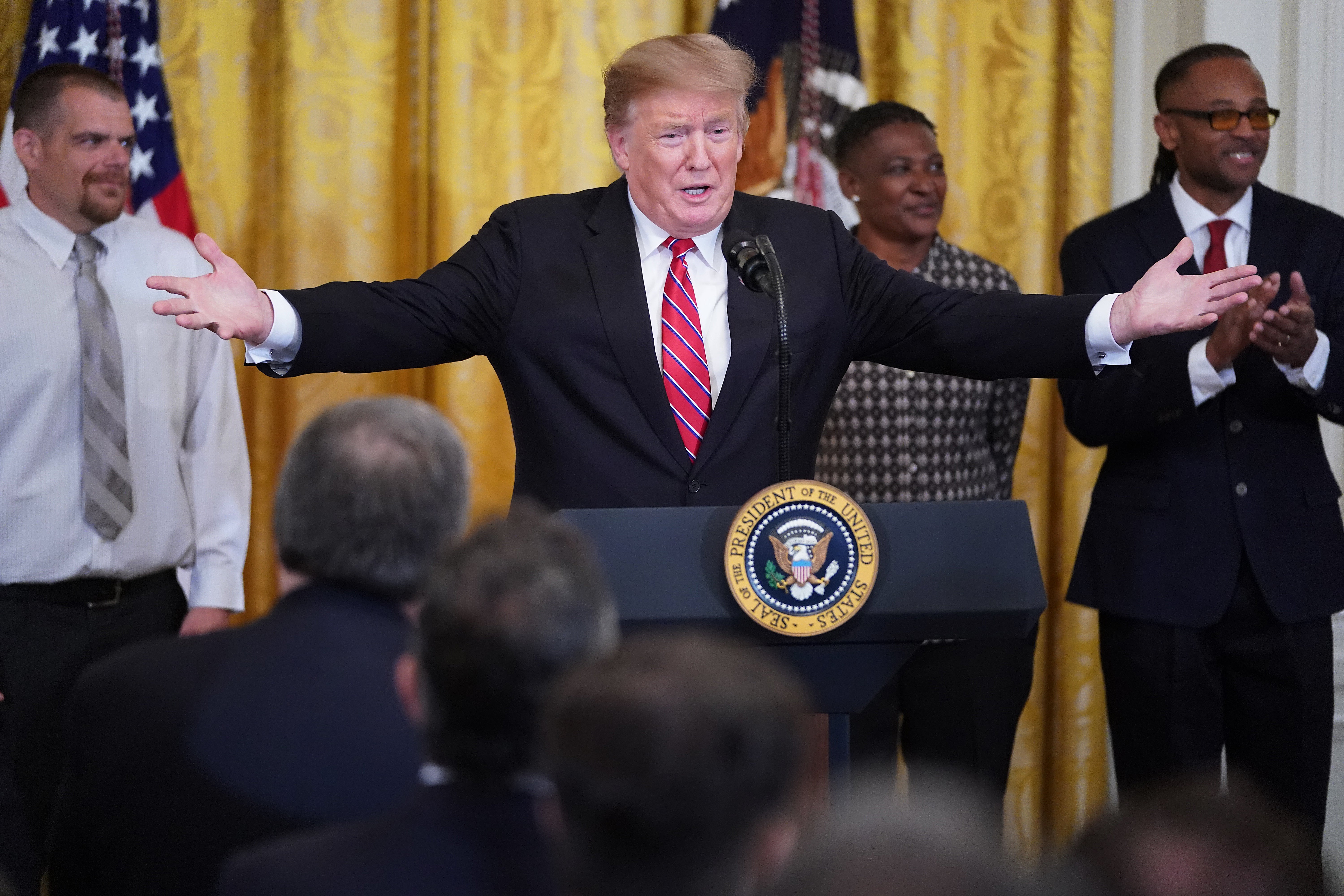 Donald Trump celebrates passage of the First Step Act at the White House with formerly incarcerated people on 1 April, 2019.
