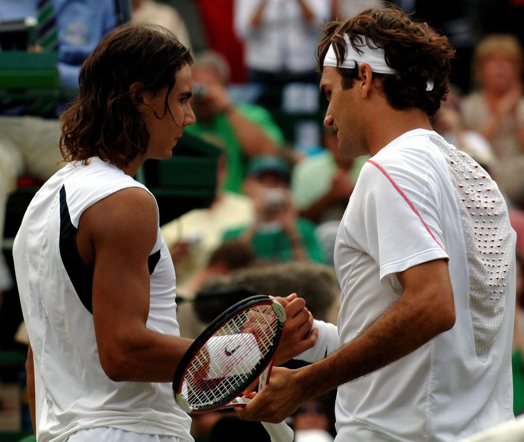 Federer shakes hands with Nadal after seeing off the Spaniard in four sets to secure a fourth straight Wimbledon title (Fiona Hanson/PA)