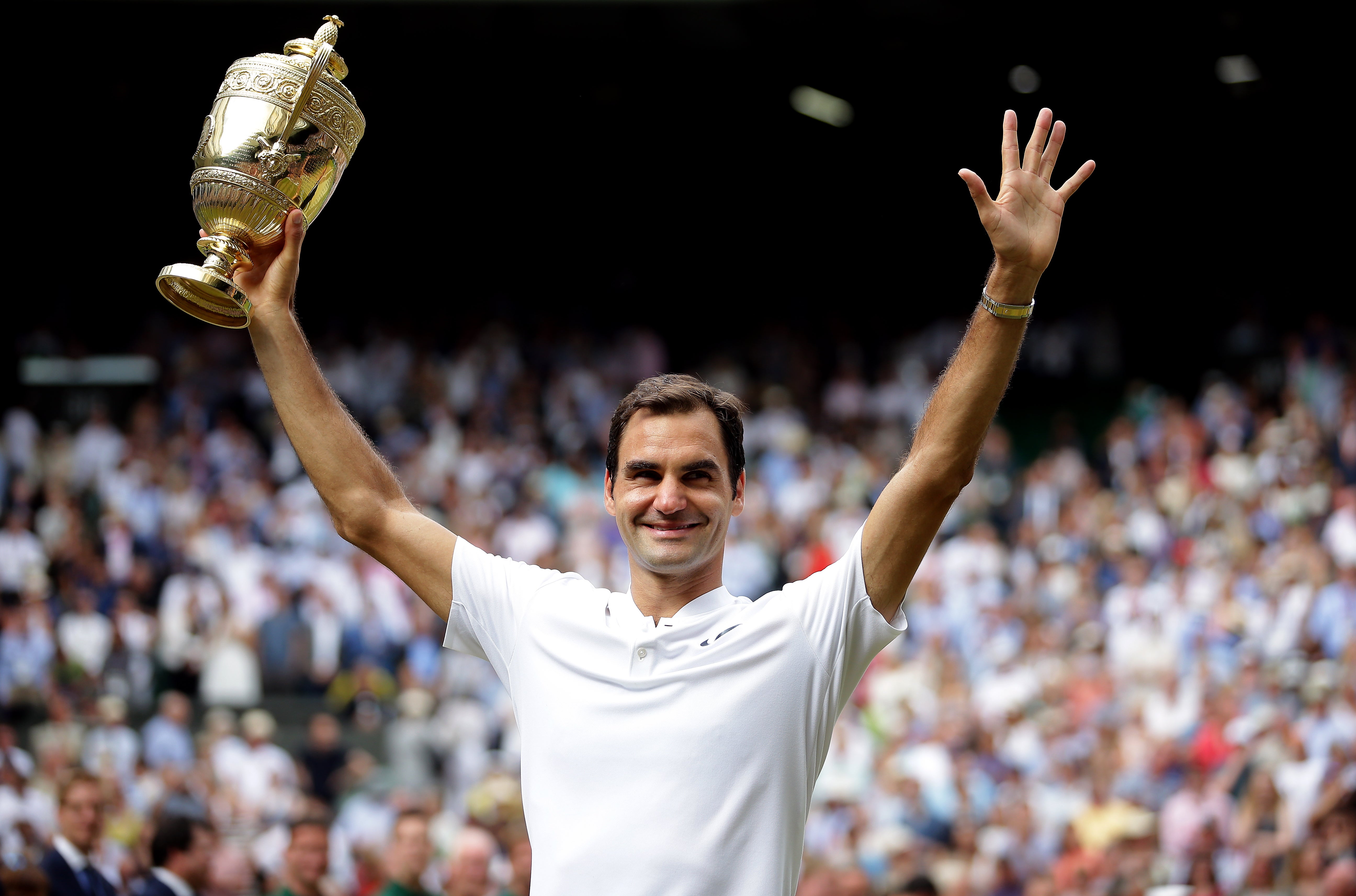 Federer celebrates after winning a record eighth Wimbledon title with victory against Marin Cilic (PA Archive/PA Images)