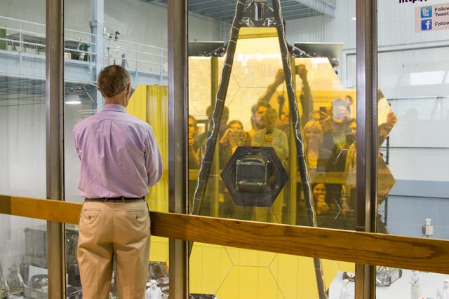 <p>Scientists view themselves in the James Webb Telescope’s primary mirror in 2017. The space telescope was launched in late 2021.</p>