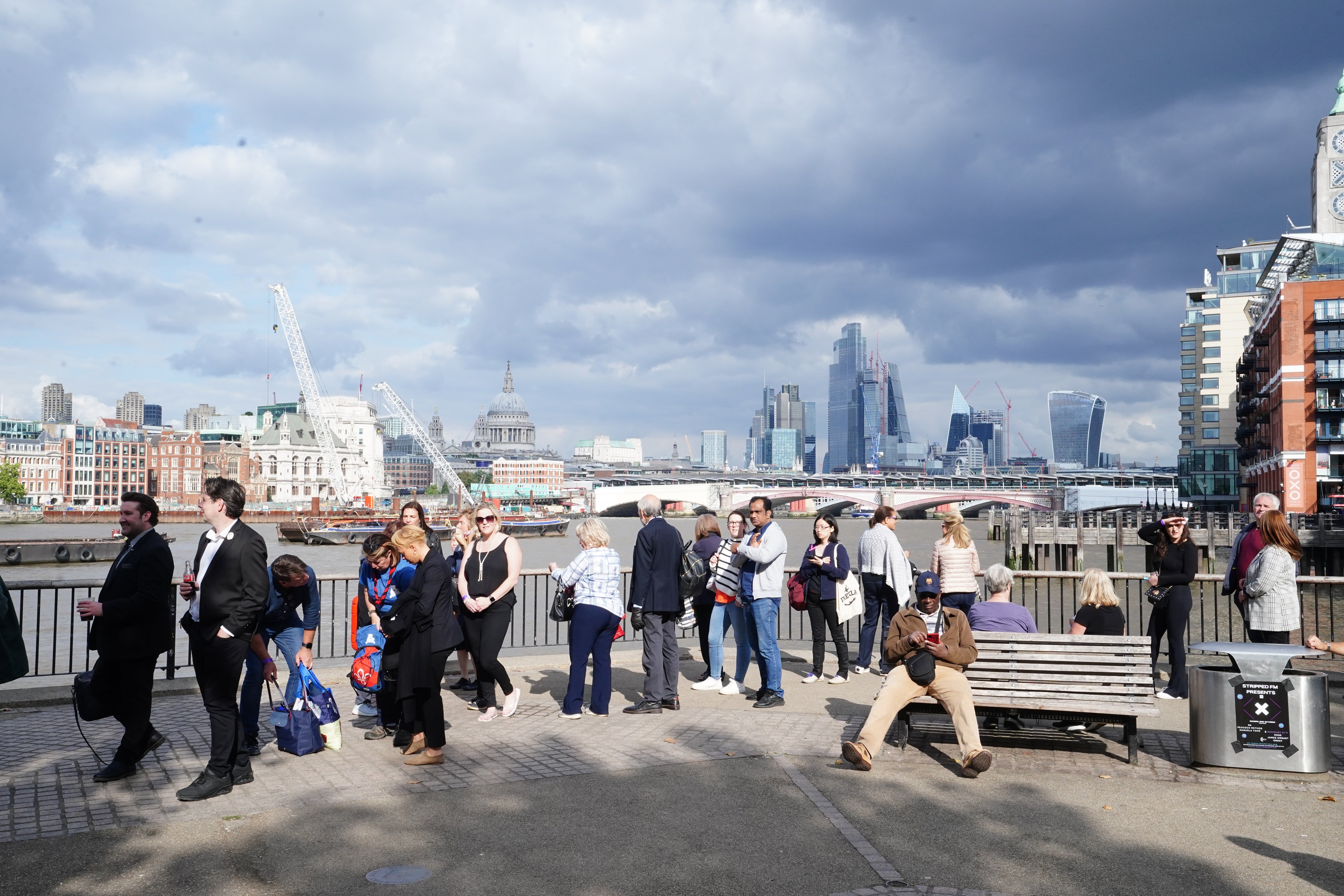 Members of the public queue on the South Bank in London to see the Queen lying in state (Ian West/PA)