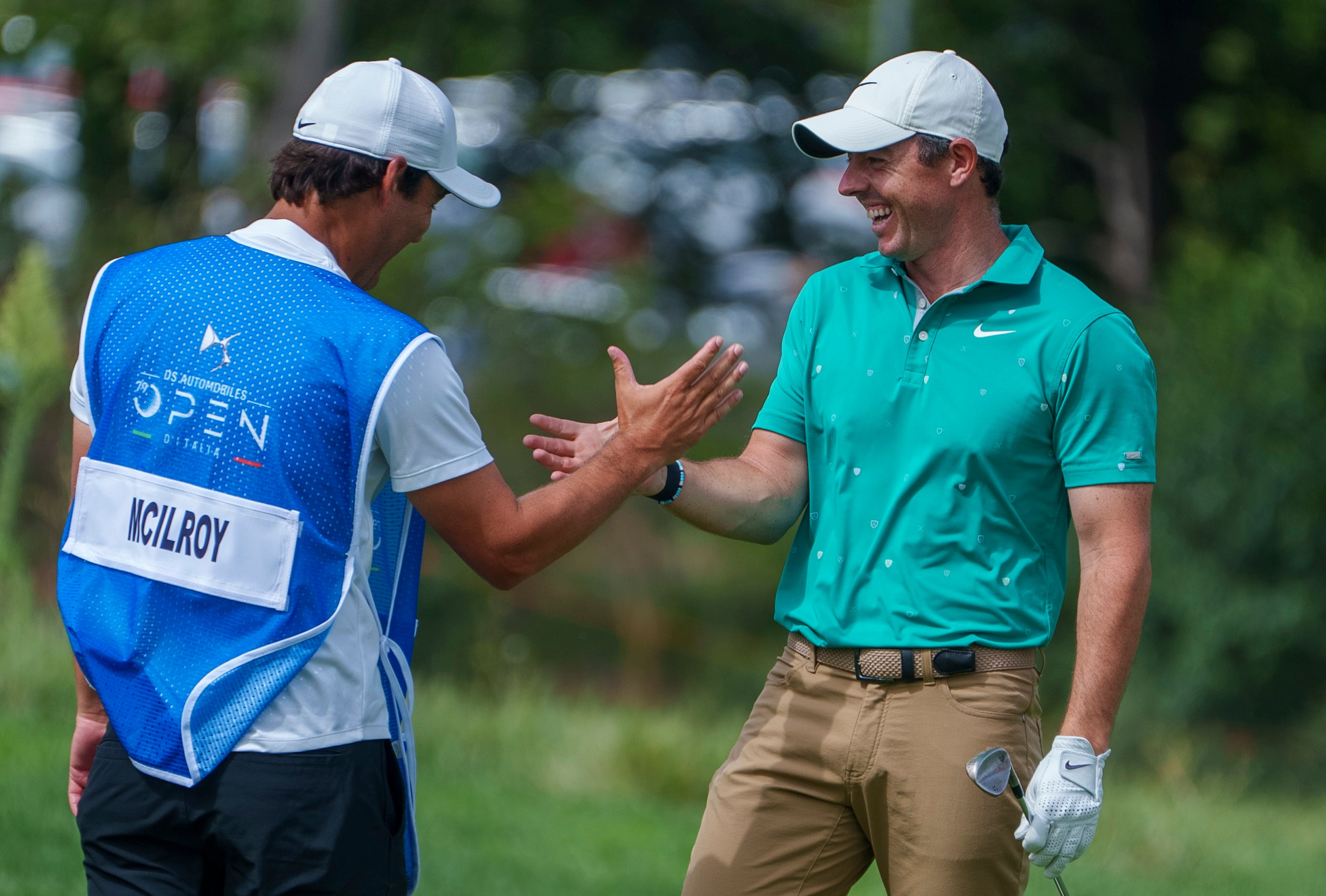 Rory McIlroy (right) is congratulated by his caddie Harry Diamond after his eagle during the first round of the Italian Open (Domenico Stinellis/AP)