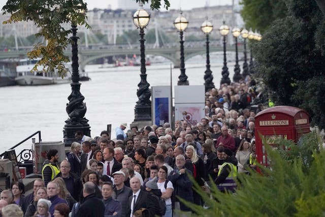 Members of the public queue on the South Bank in London, as they wait to view the Queen lying in state (Victoria Jones/PA)