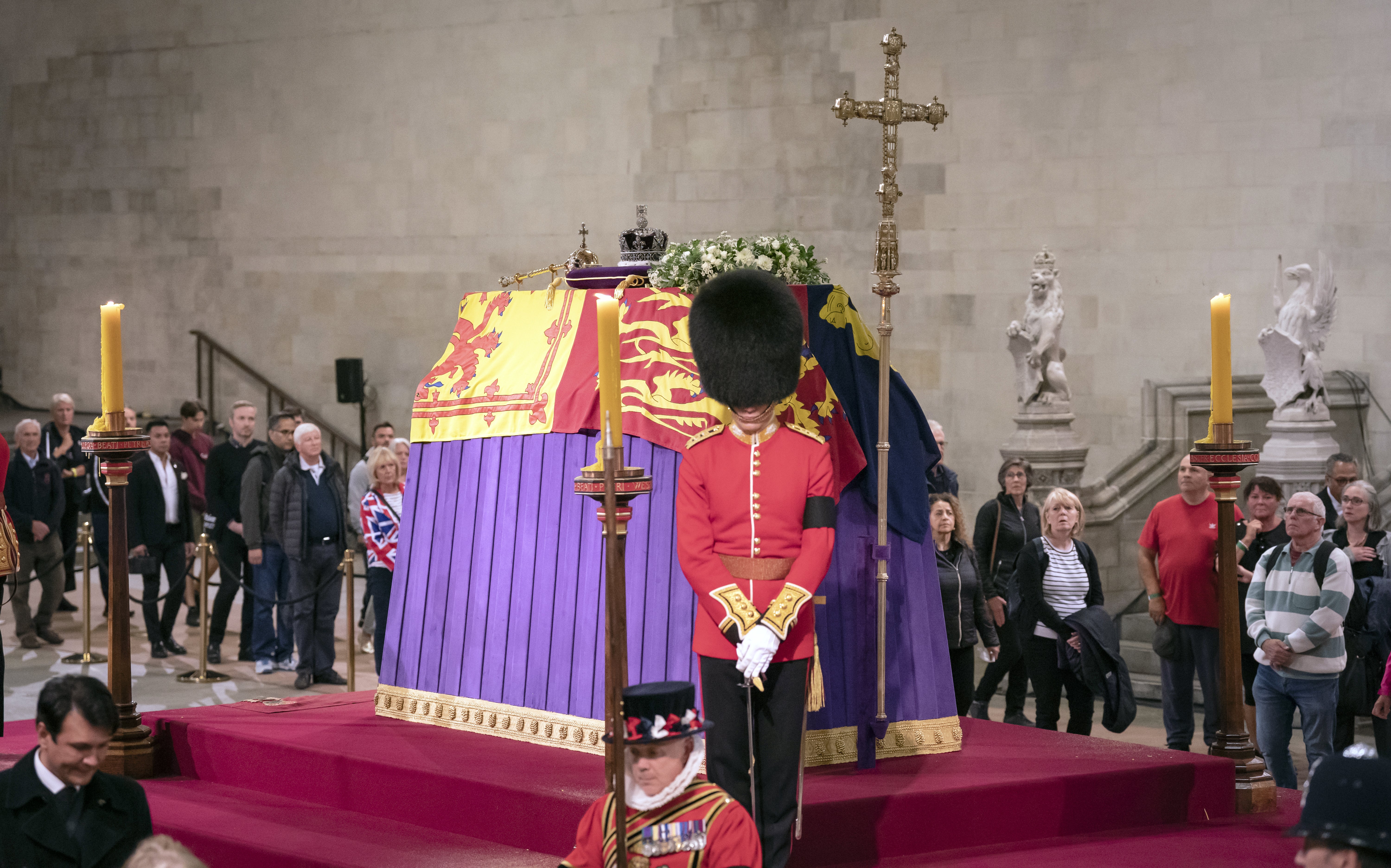 Members of the public file past the Queen’s coffin as it lies in state in Westminster
