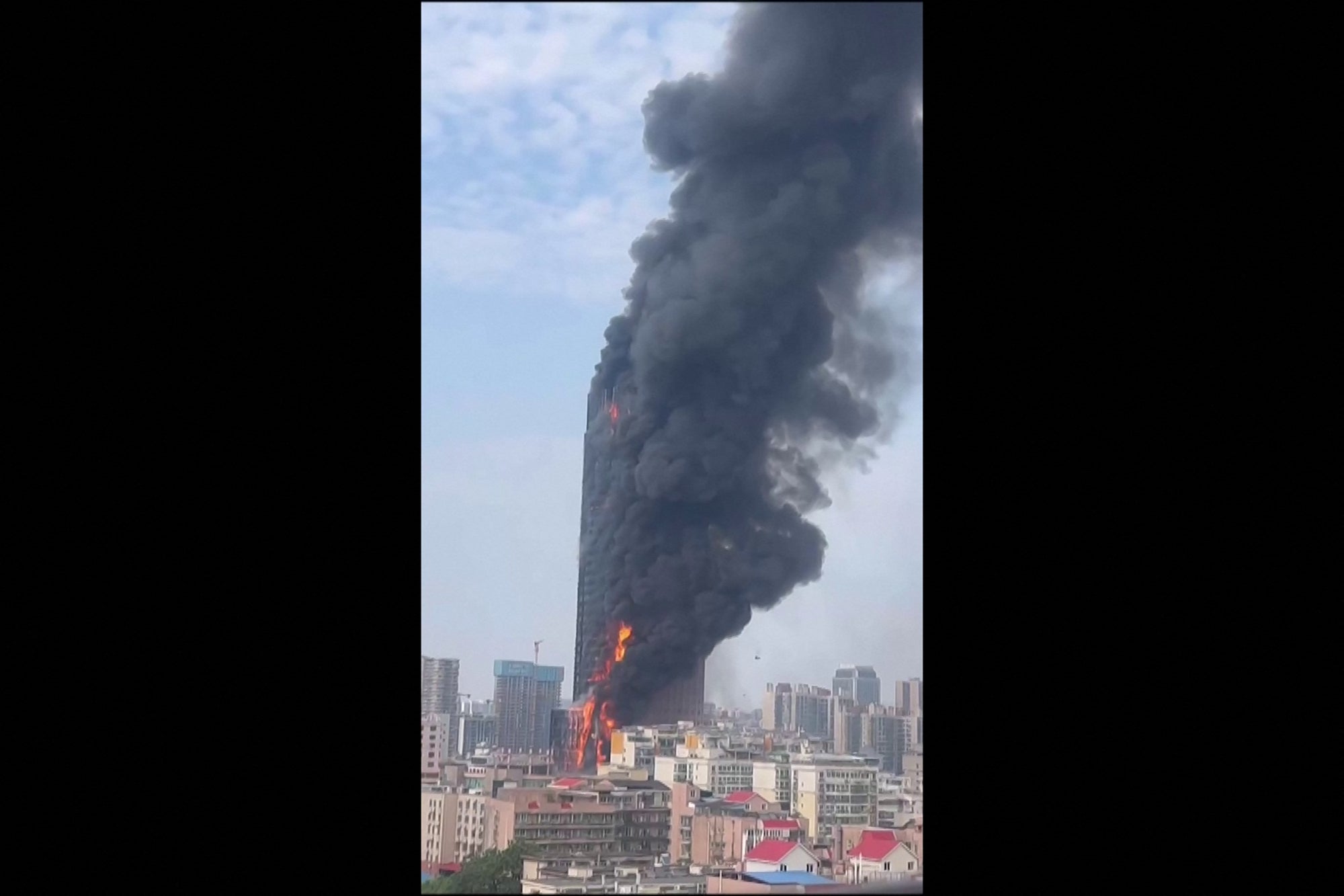This screengrab taken from a video provided to AFPTV by an anonymous source on 16 September 2022 shows thick smoke billowing from a skyscraper in Changsha, Hunan