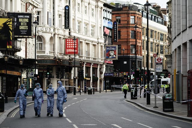 Forensics officers and police at the scene in Shaftesbury Avenue, central London (Aaron Chow/PA)