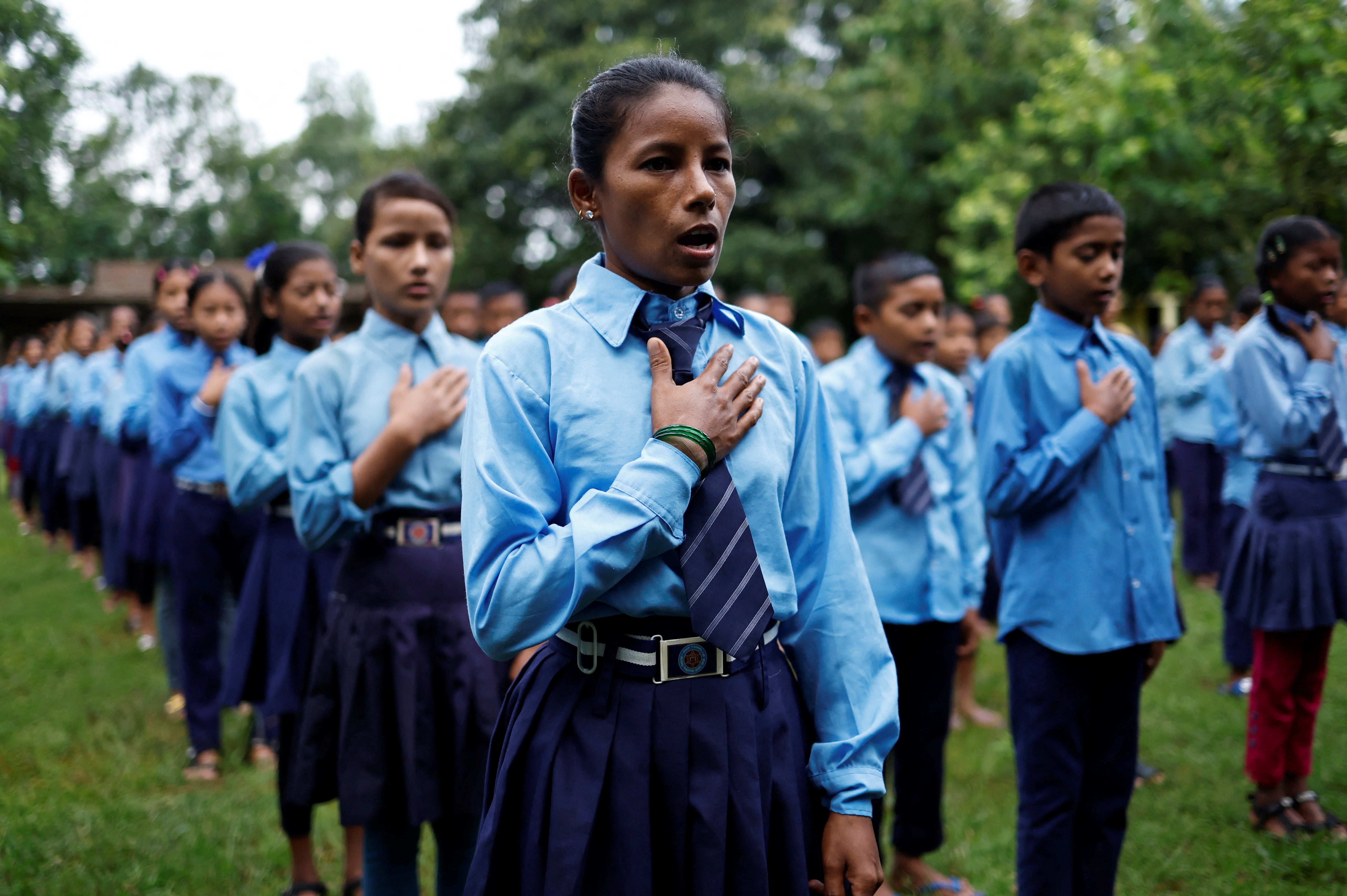 Parwati Sunar, 27, sings the national anthem of Nepal during assembly at Jeevan Jyoti secondary school in Punarbas