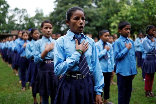 <p>Parwati Sunar, 27, sings the national anthem of Nepal during assembly at Jeevan Jyoti secondary school in Punarbas</p>