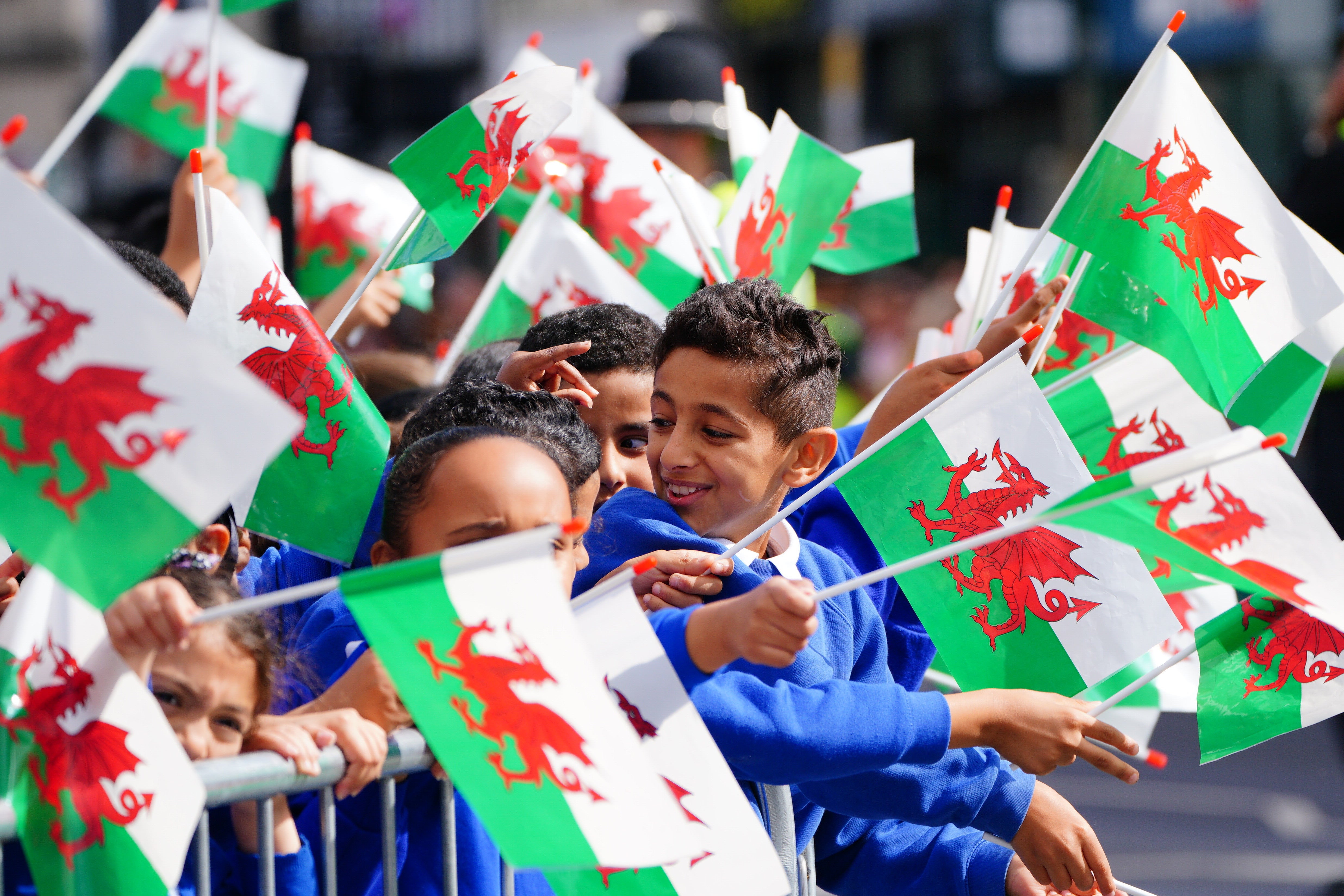 Schoolchildren wait for King Charles III to arrive at Cardiff Castle (Ben Birchall/PA)