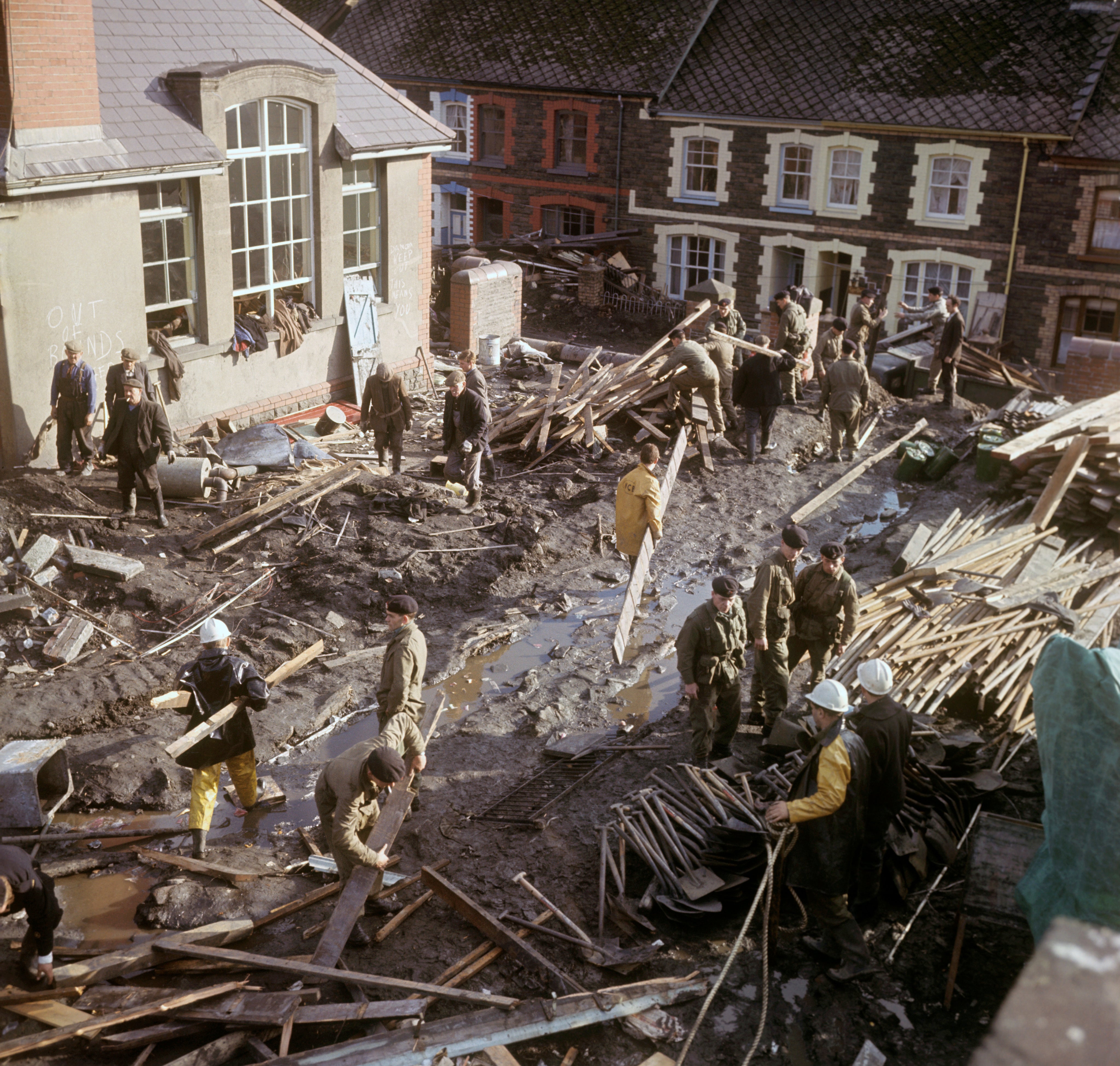 Soldiers and miners at work amid the wreckage after a coal tip slid down the mountain and buried children in their school in the South Wales mining village of Aberfan (PA)