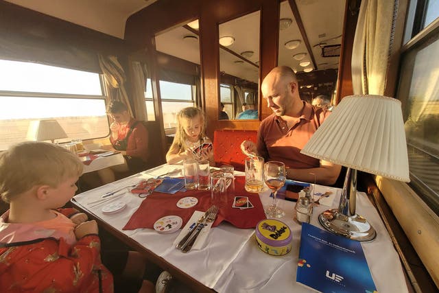 <p>Dom and the kids in the Hungarian train’s dining car</p>