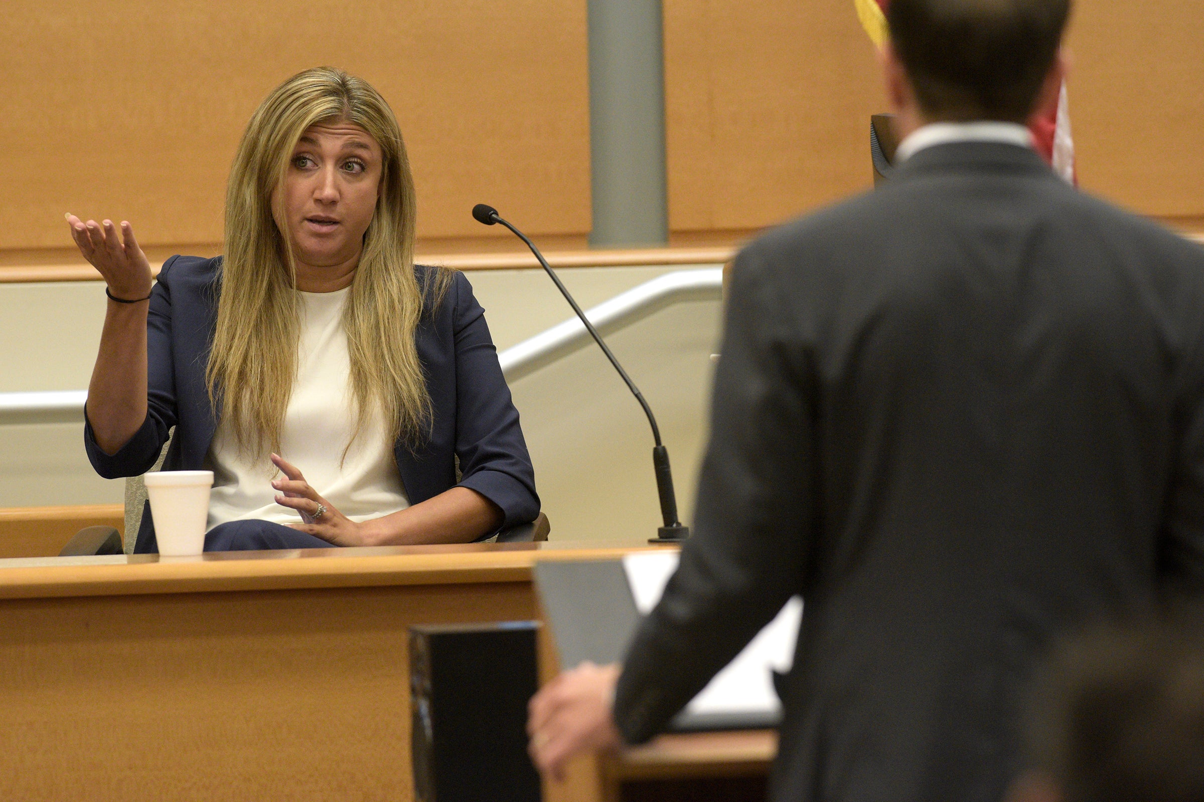 Brittany Paz, a lawyer hired by Alex Jones to testify about his companies, is questioned by plaintiff's attorney Chris Mattei during Jones' Sandy Hook defamation damages trial
