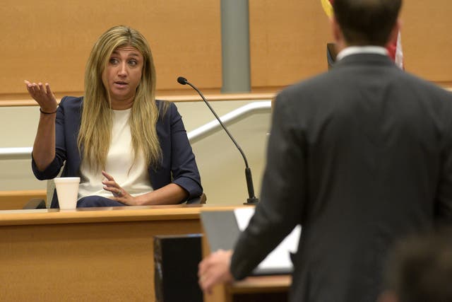 <p>Brittany Paz, a lawyer hired by Alex Jones to testify about his companies, is questioned by plaintiff's attorney Chris Mattei during Jones' Sandy Hook defamation damages trial </p>