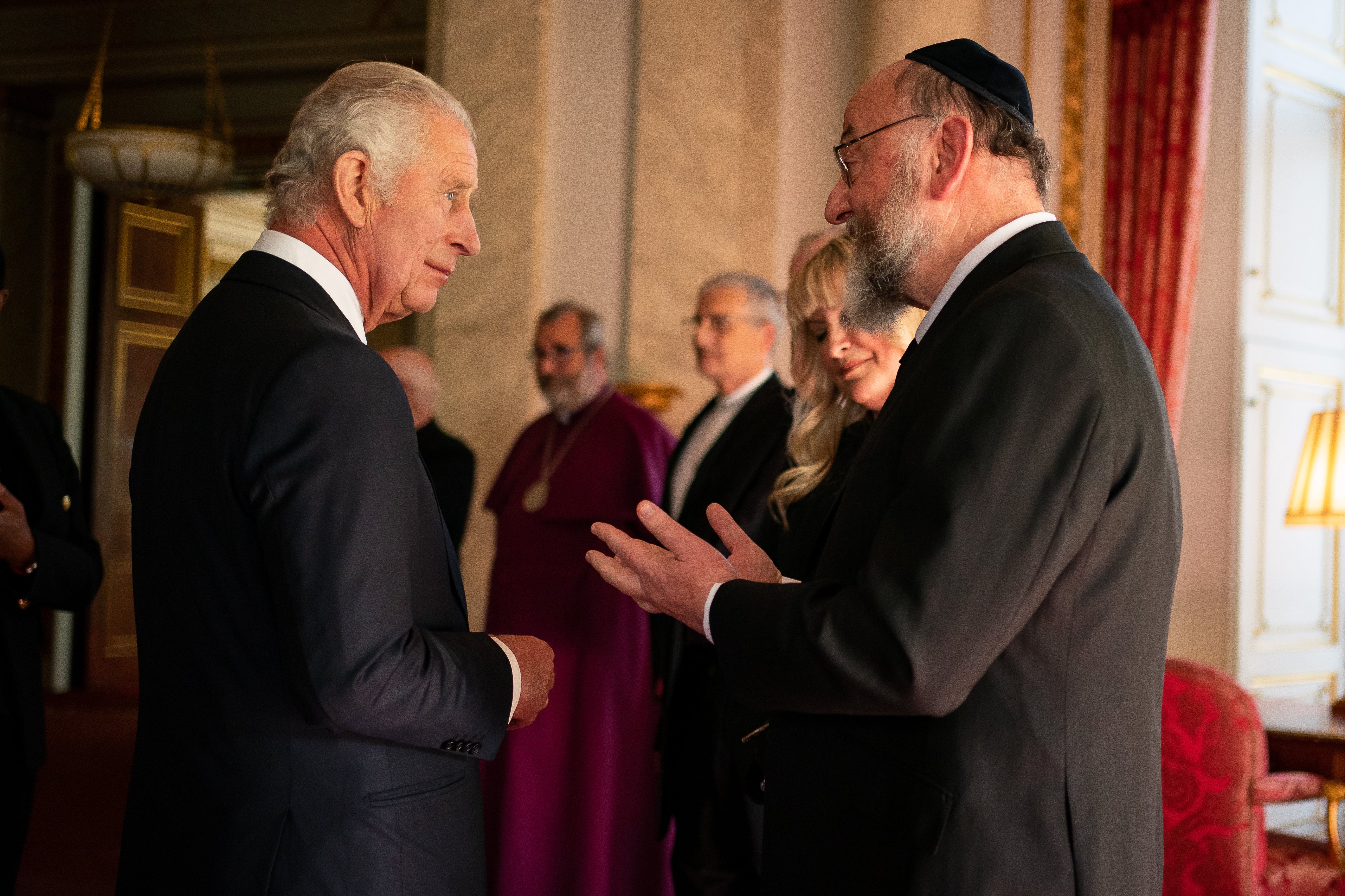 King Charles speaks to Chief Rabbi Ephraim Mirvis (Aaron Chown/PA)