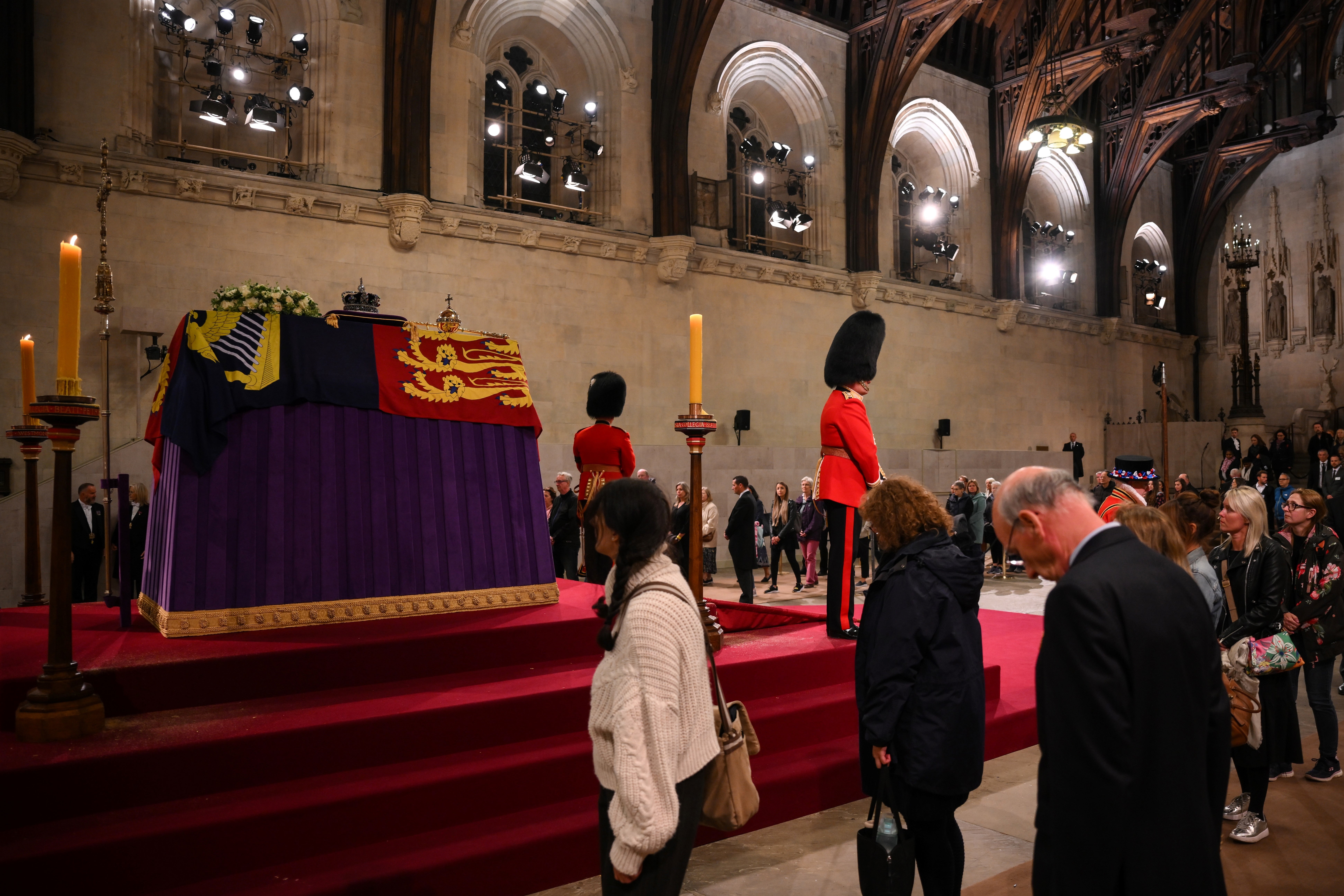 Members of the public file past the coffin of Queen Elizabeth II, draped in the Royal Standard with the Imperial State Crown and the Sovereign’s orb and sceptre, lying in state on the catafalque in Westminster Hall (Daniel Leal/PA)