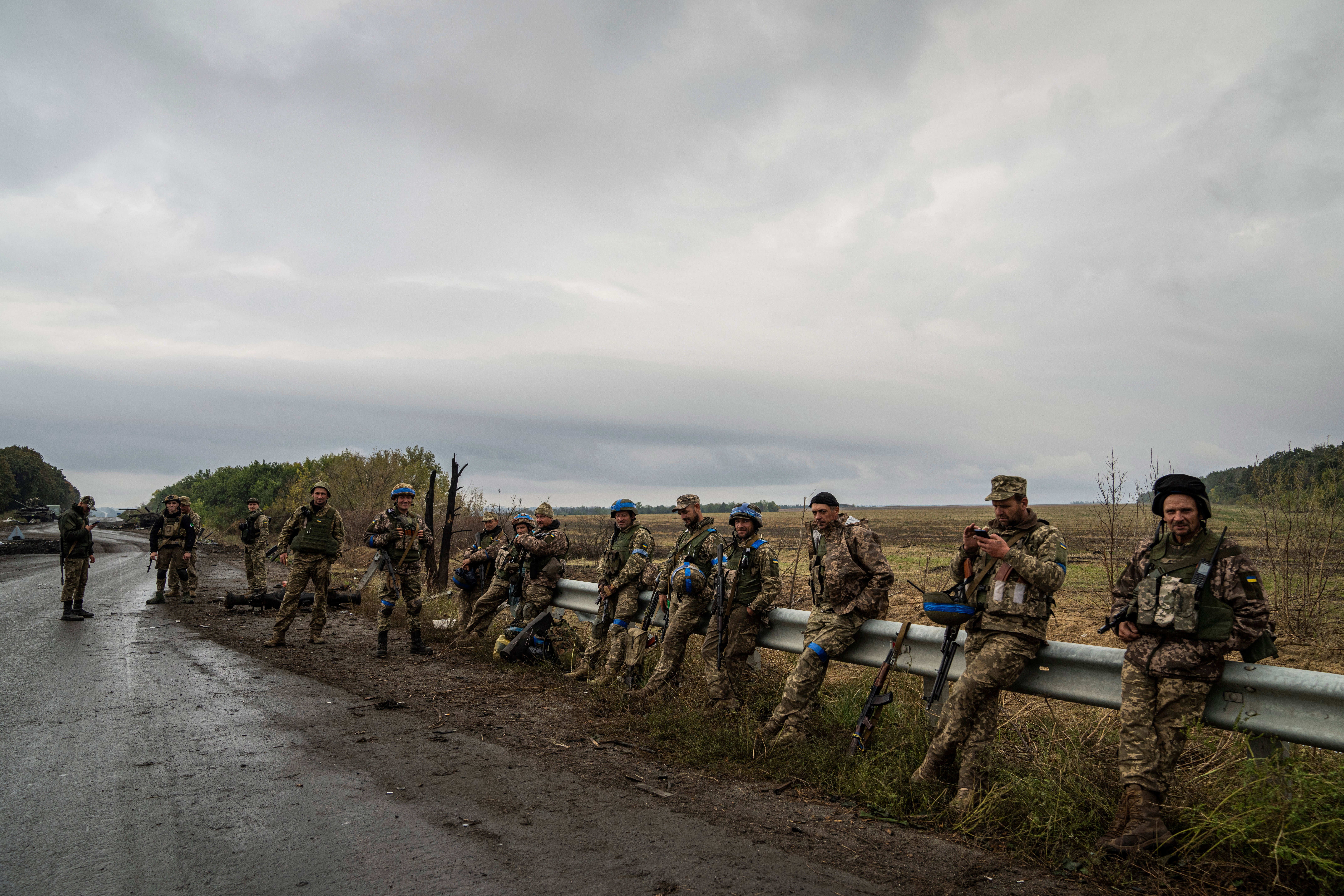 Ukrainian servicemen rest at a former Russian position in the recently retaken area of Izium