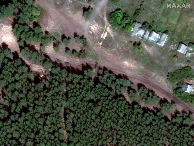 <p>Satellite images appear to show tanks near the site of a mass grave in Ukrainian months before its discovery</p>