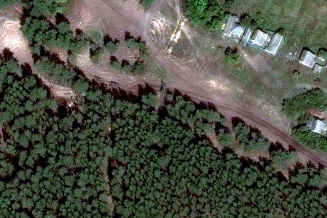 <p>Satellite images appear to show tanks near the site of a mass grave in Ukrainian months before its discovery</p>