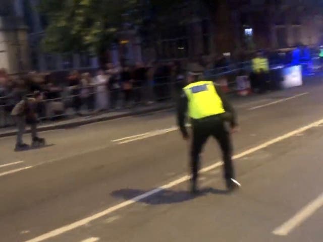 <p>Police charge towards a rollerskater ahead of King Charles’ motorcade passing by</p>
