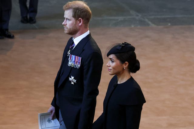 <p>File Prince Harry and Meghan, Duchess of Sussex walk as procession with the coffin of Britain's Queen Elizabeth arrives at Westminster Hall </p>