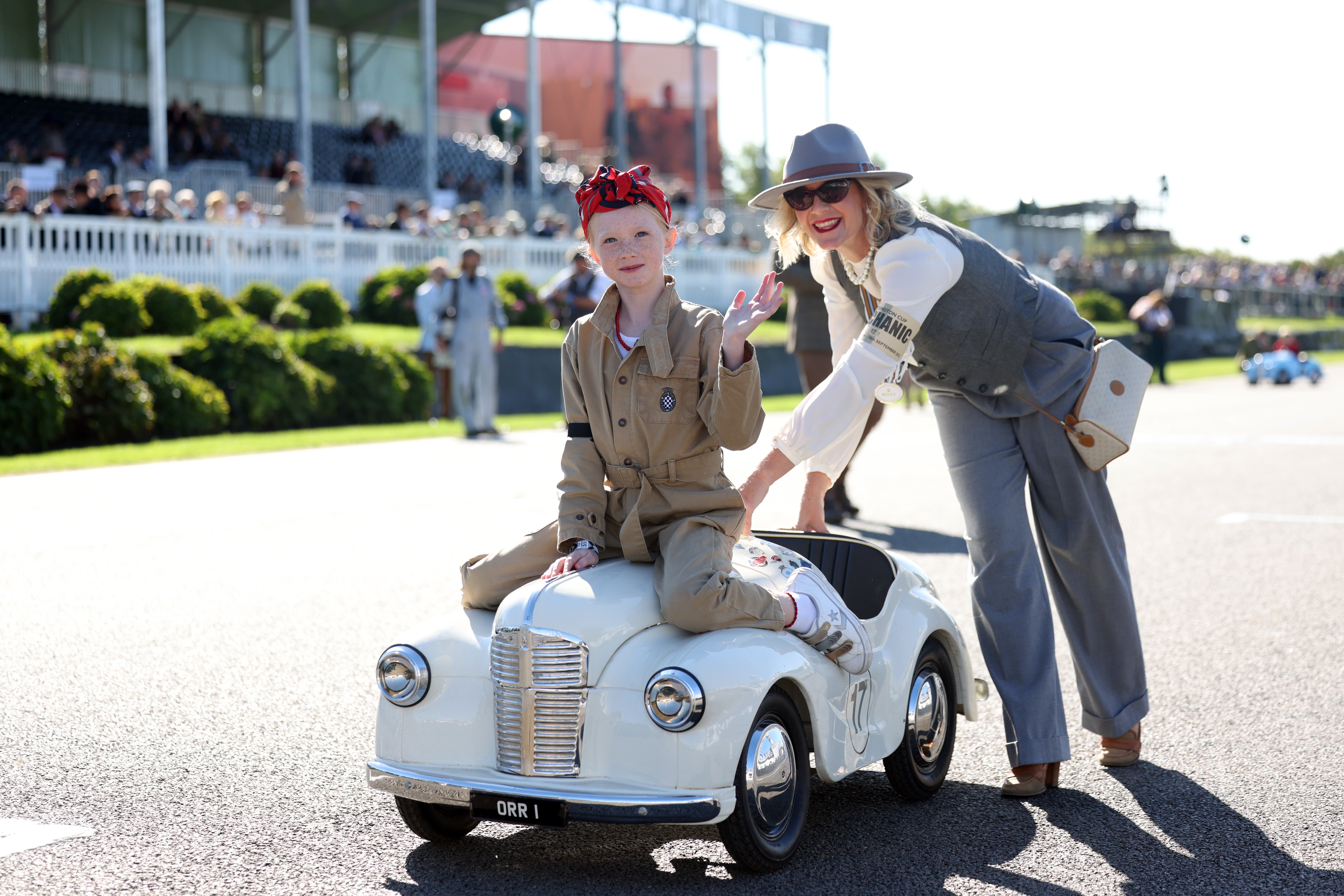 An adult wearing a ‘mechanic’ armband helps one young racer to the start line (Matt Alexander/PA)