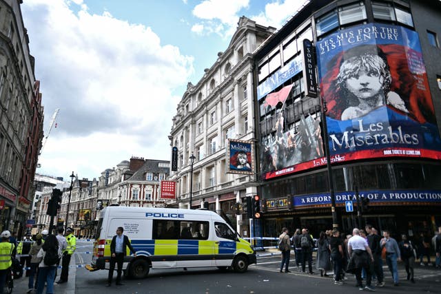 <p>Police officers stand on duty by a cordon on Shaftesbury Avenue in central London following the stabbing of two police officers</p>