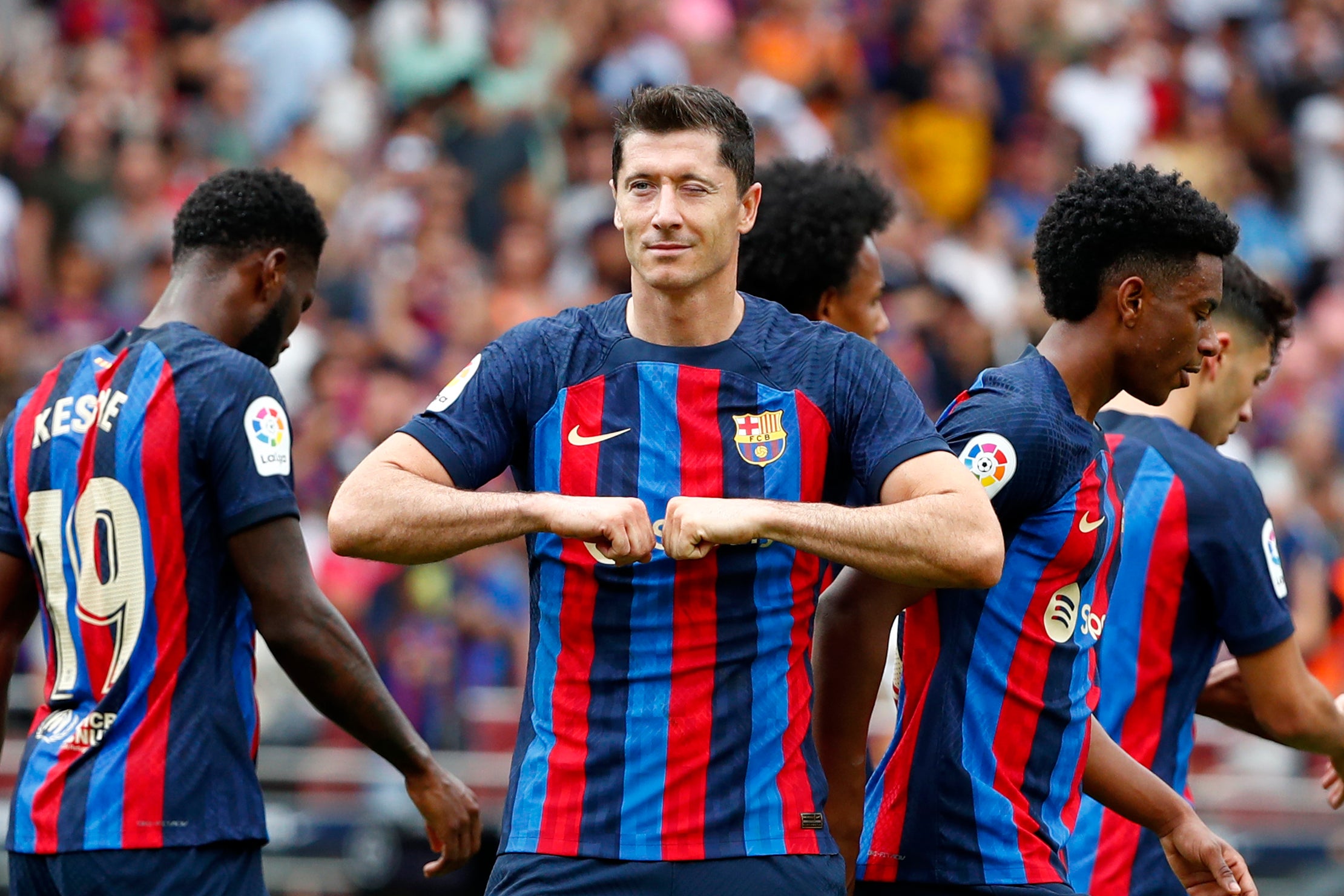 Robert Lewandowski celebrates after opening the scoring for Barcelona against Elche (Joan Monfort/AP)