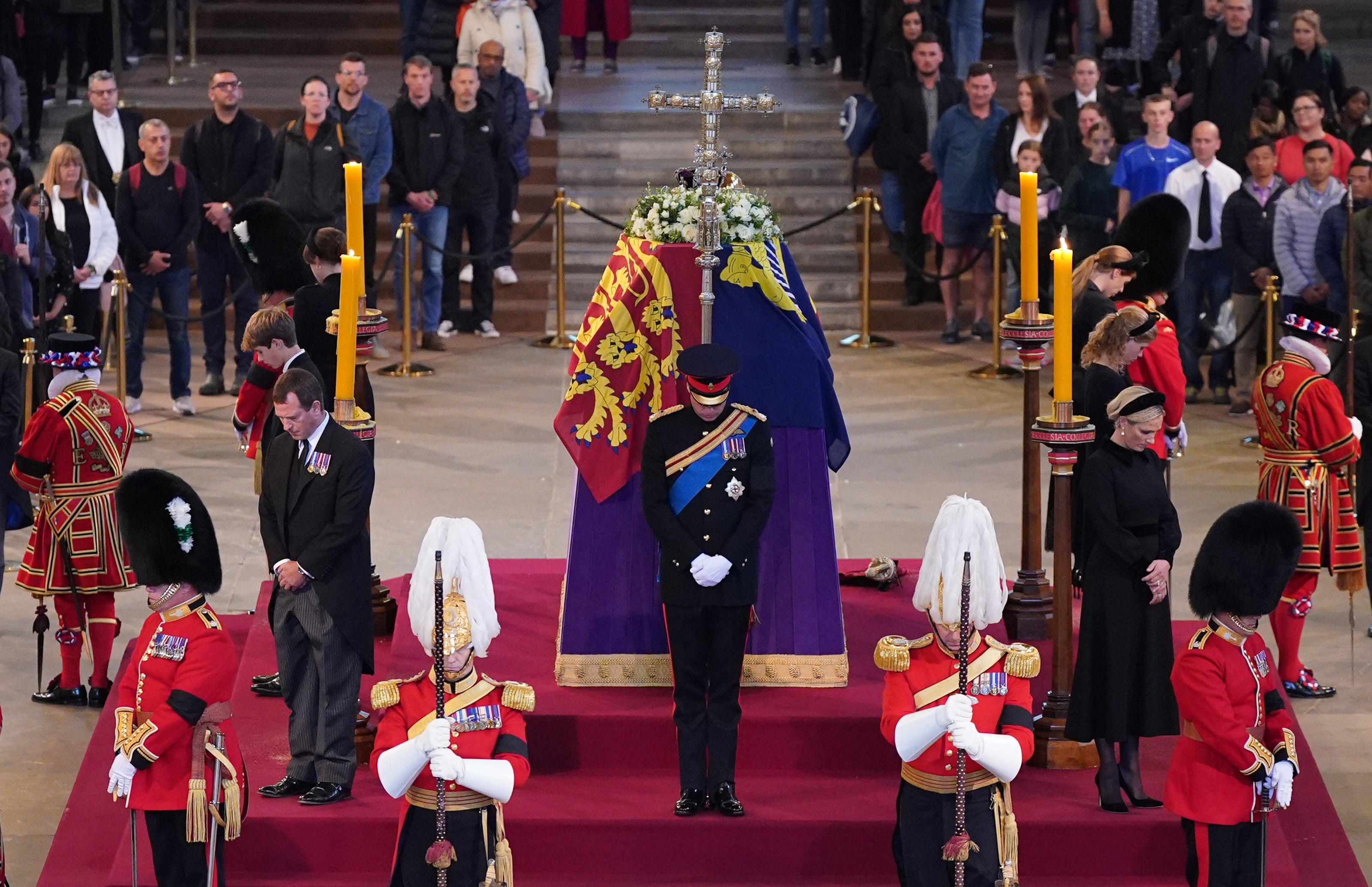 Queen Elizabeth II’s grandchildren hold a vigil beside her coffin as it lies in state on the catafalque in Westminster Hall (Yui Mok/PA)