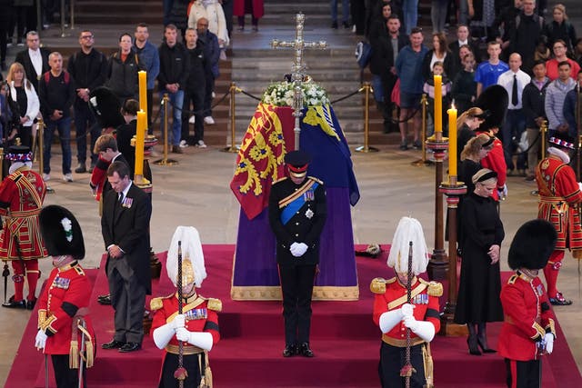 Queen Elizabeth II’s grandchildren hold a vigil beside her coffin as it lies in state on the catafalque in Westminster Hall (Yui Mok/PA)