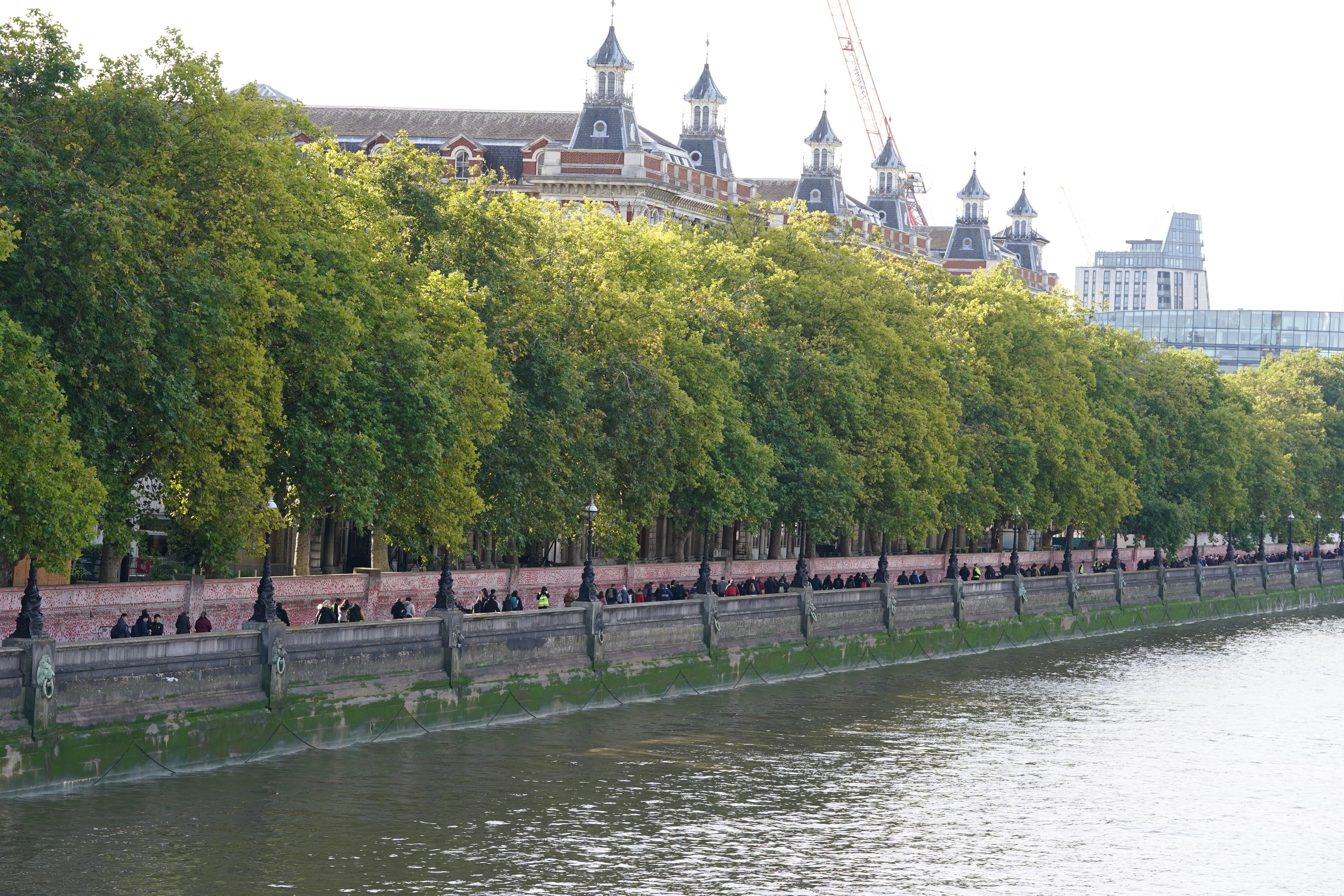 Members of the public queue between Westminster Bridge towards Lambeth Bridge in London, as they wait to view the Queen lying in state (Gareth Fuller/PA)