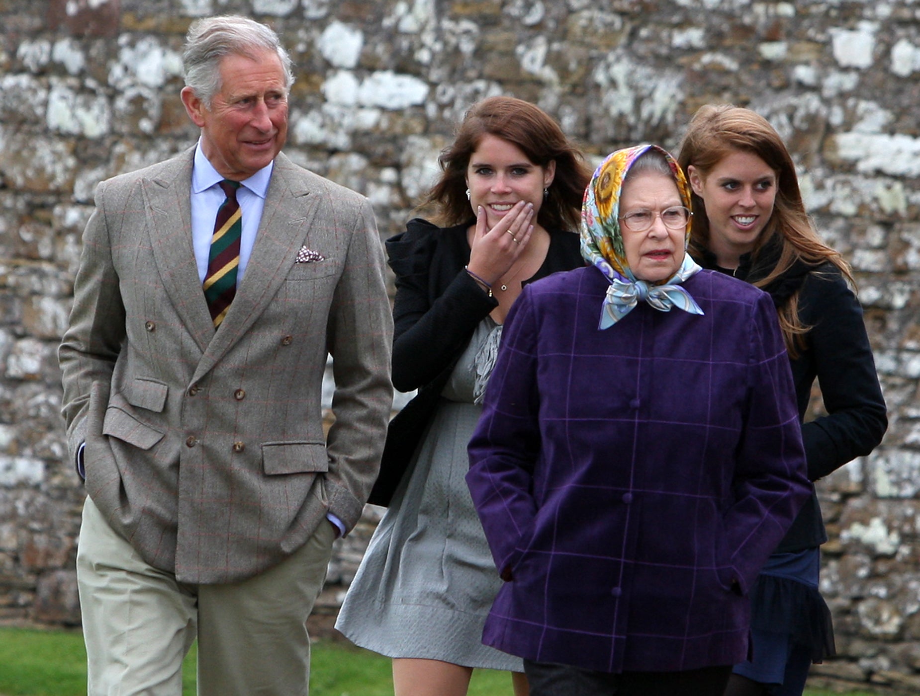 Queen Elizabeth II (R) accompanied by Prince Charles, Prince of Wales (L), Princess Eugenie, (C), and Princess Beatrice and the rest of the Royal family arrive at the Castle of Mey in 2010