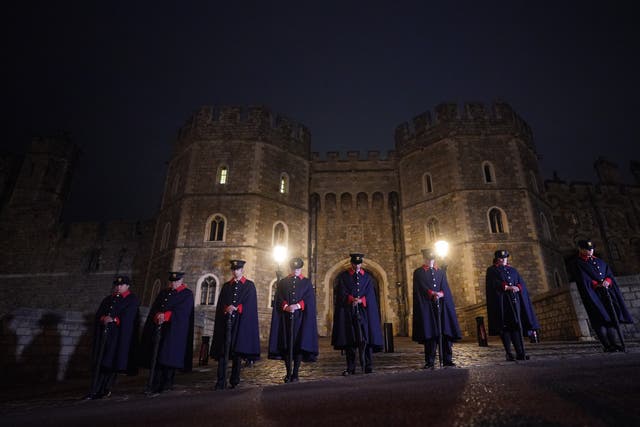 Castle Wardens observe the national minute’s silence in memory of the Queen at Windsor Castle (Victoria Jones/PA)