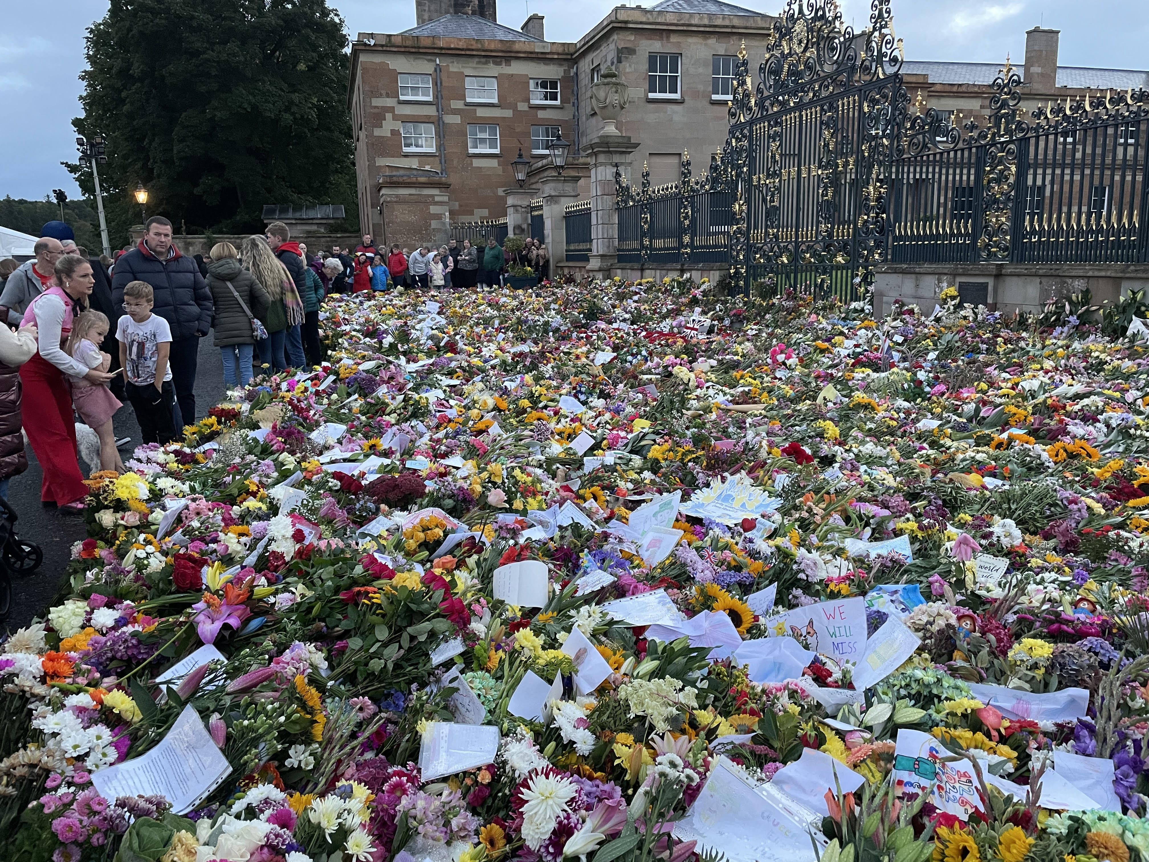 Floral tributes left outside Hillsborough Castle (Jonathan McCambridge/PA)