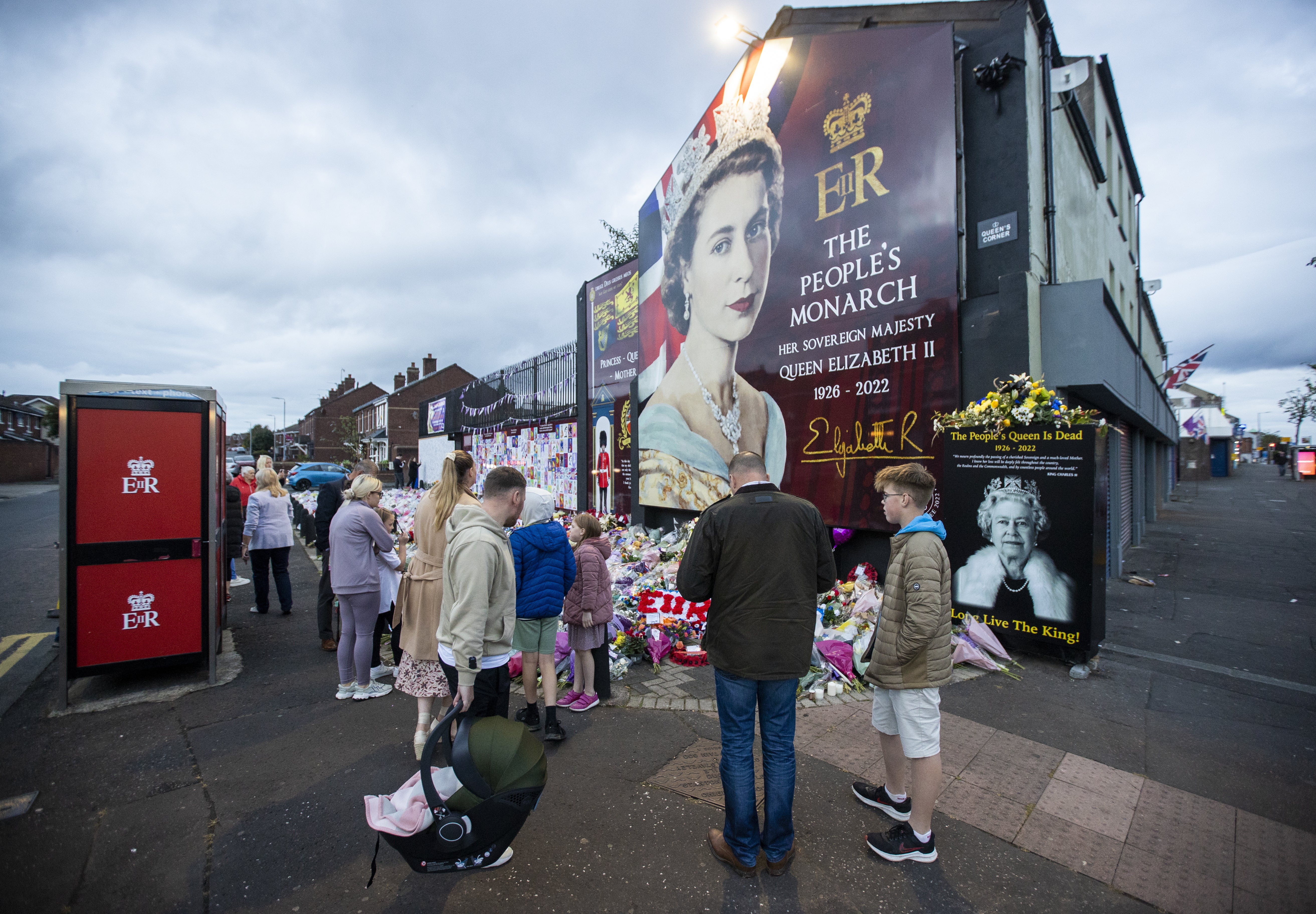 Members of the public visit a mural to the Queen on the Shankill Road (Liam McBurney/PA)