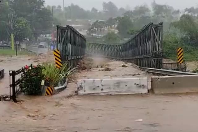 <p>The post-2017 bridge in Utuado, Puerto Rico, being washed away by Hurricane Fiona on Sunday 18 September 2022</p>