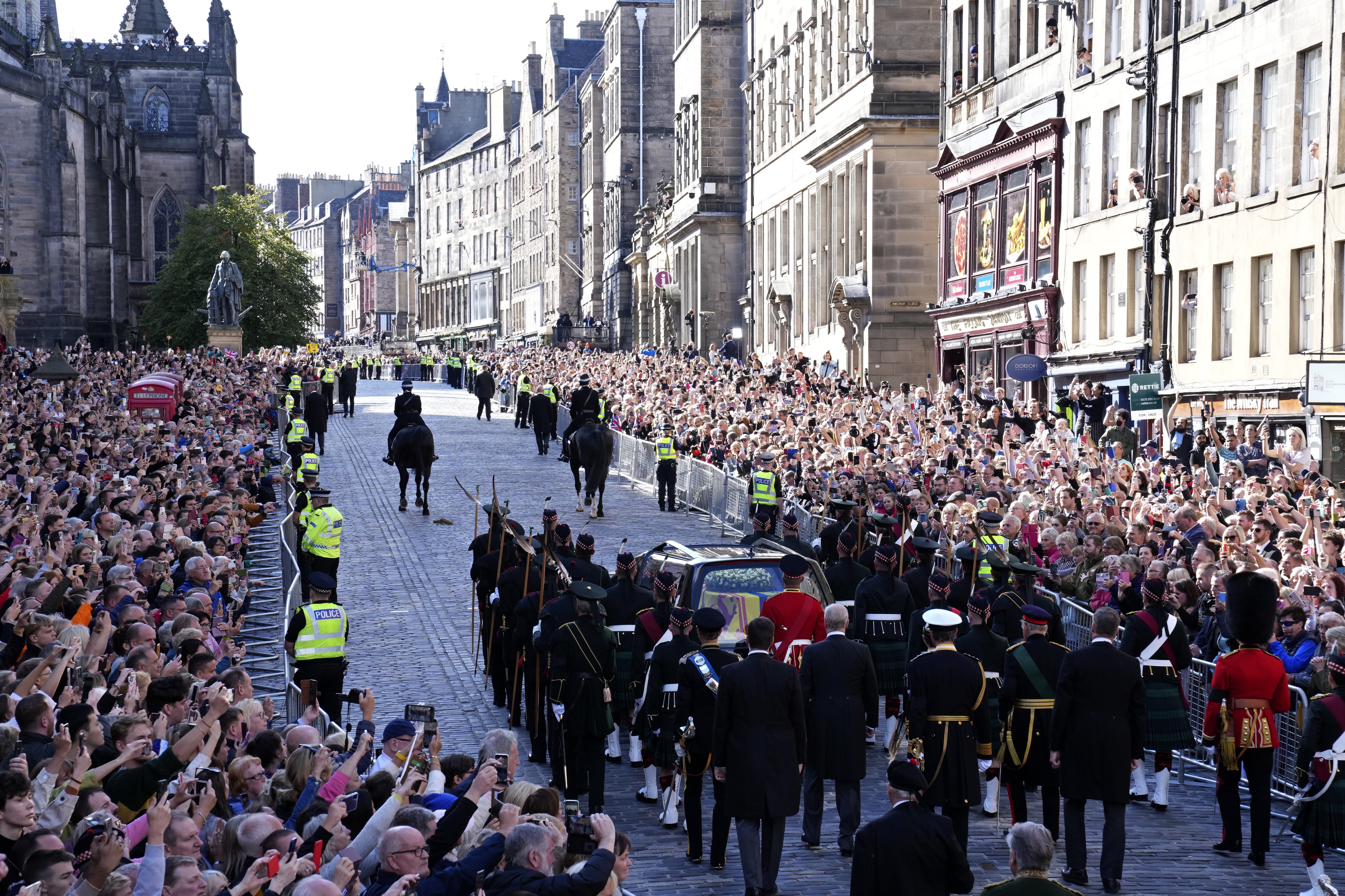 The procession of the Queen’s coffin from the Palace of Holyroodhouse to St Giles’ Cathedral moves along the Royal Mile (Jane Barlow/PA)