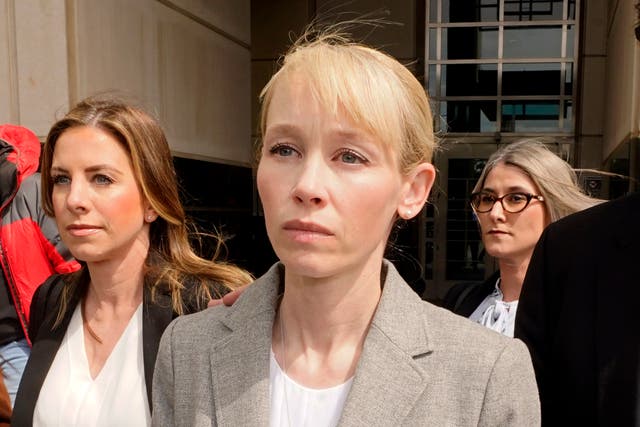 <p>Sherri Papini of Redding leaves the federal courthouse accompanied by her attorney, William Portanova, right, after her arraignment in Sacramento, Calif., Wednesday, April 13, 2022 </p>
