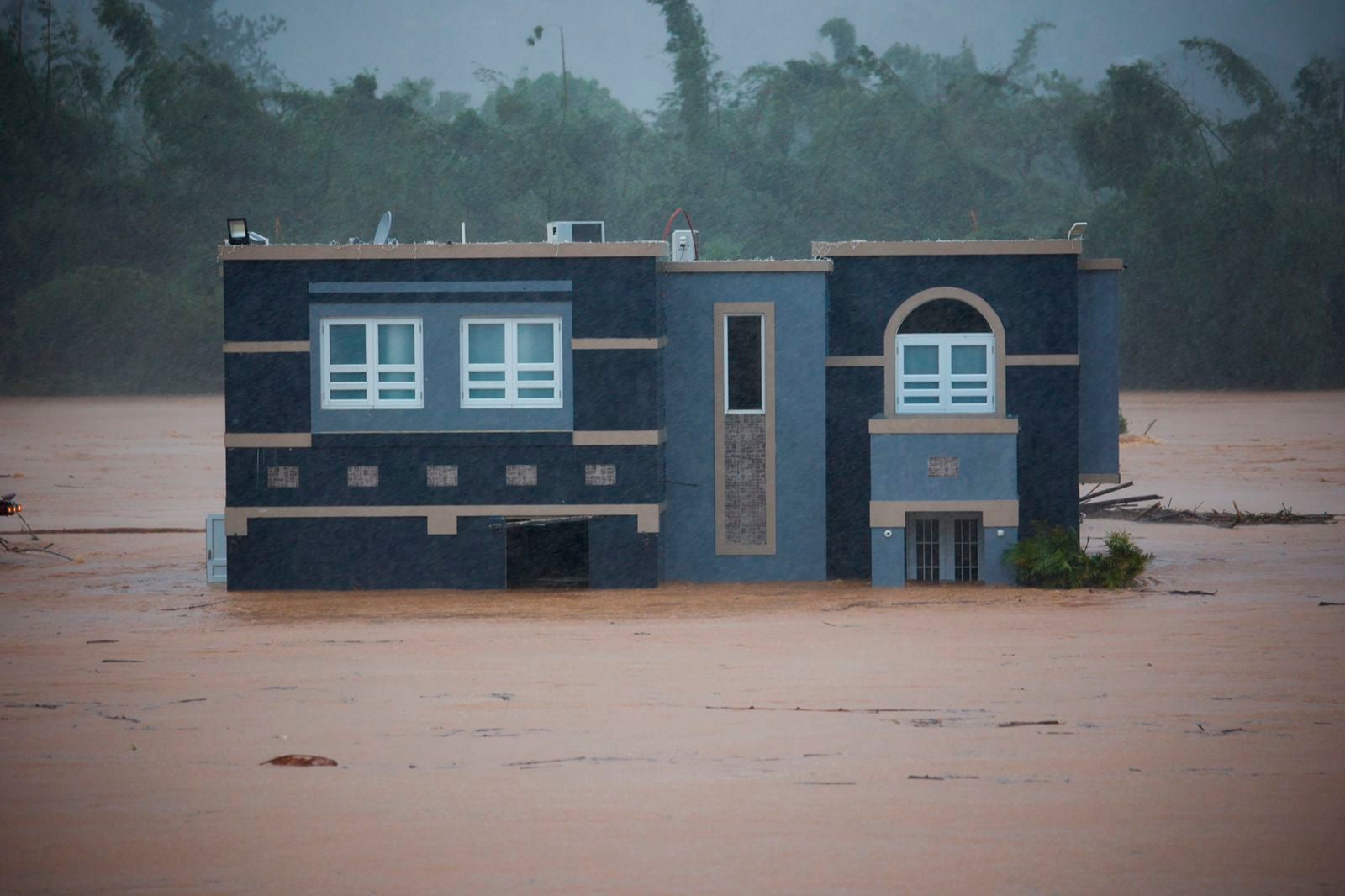 A home is submerged in floodwaters caused by Hurricane Fiona in Cayey, Puerto Rico, Sunday, 18 September 2022