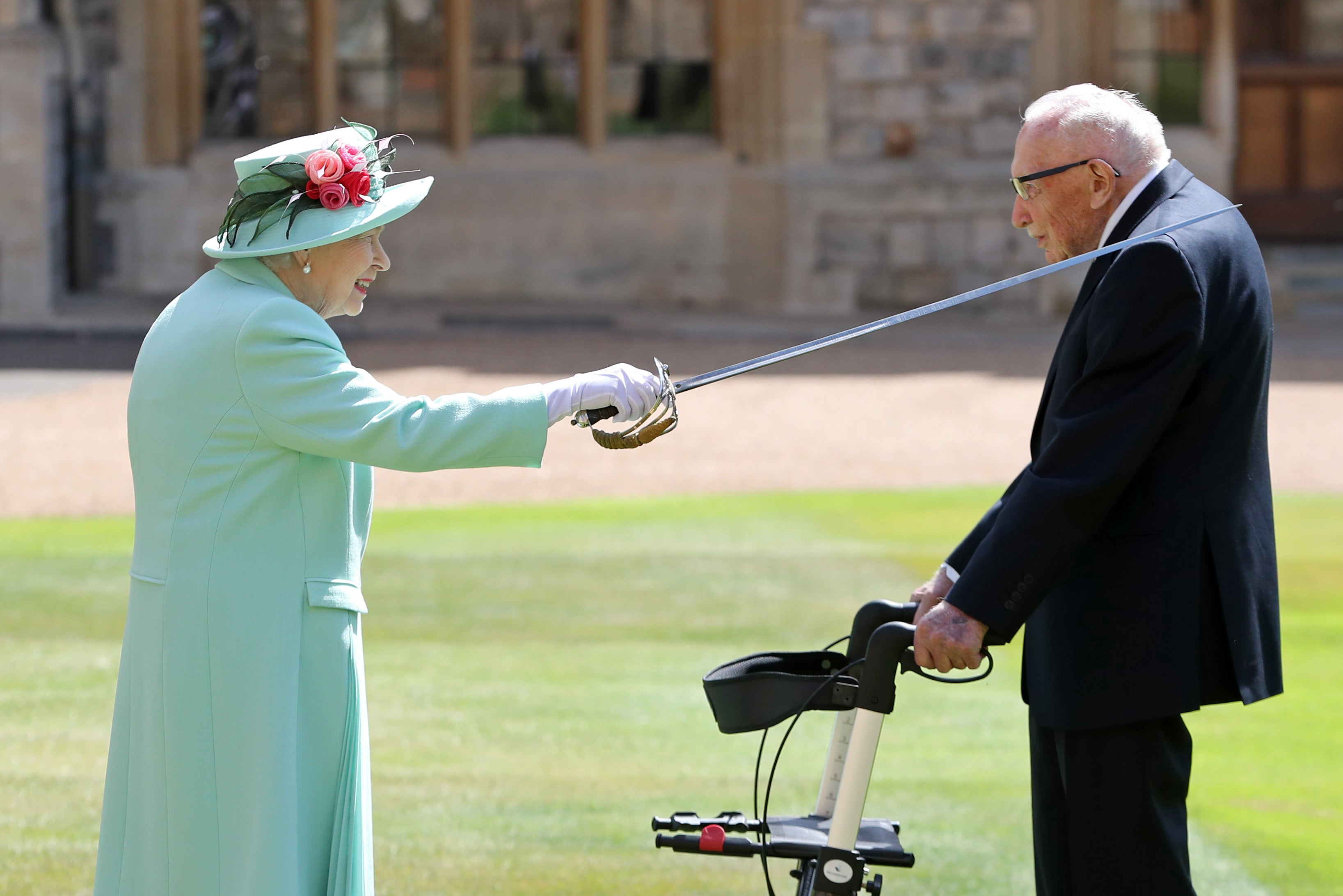 Captain Tom receiving his knighthood from Queen Elizabeth II during a ceremony at Windsor Castle in July 2020