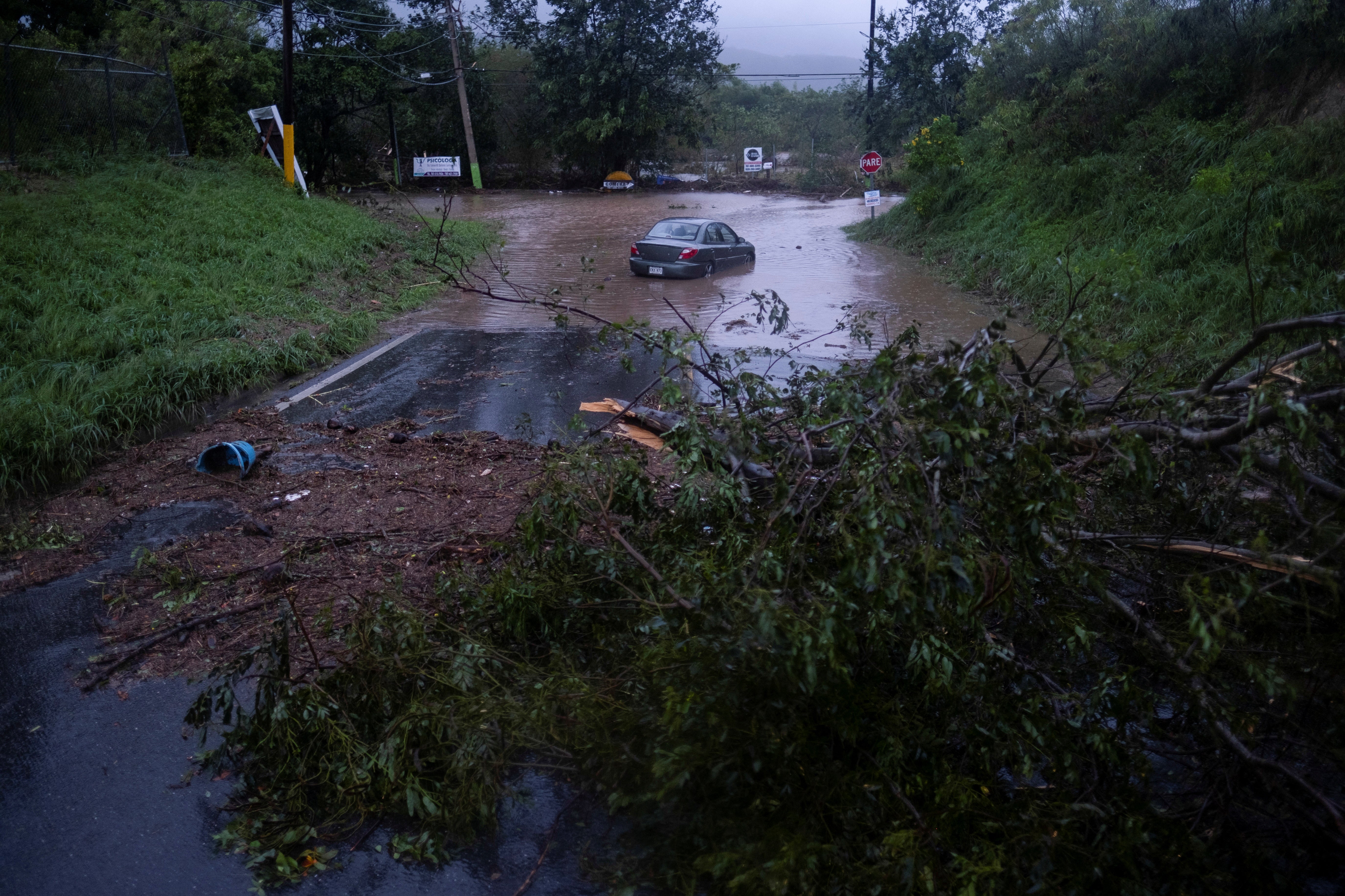 A car sits in flood waters after Hurricane Fiona affected the area in Yauco, Puerto Rico, 18 September 2022