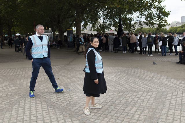 Priti Patel and Andrew Stephenson were among the volunteers marshalling the queue of mourners paying their respects to the Queen. (Dan Barker/PA)