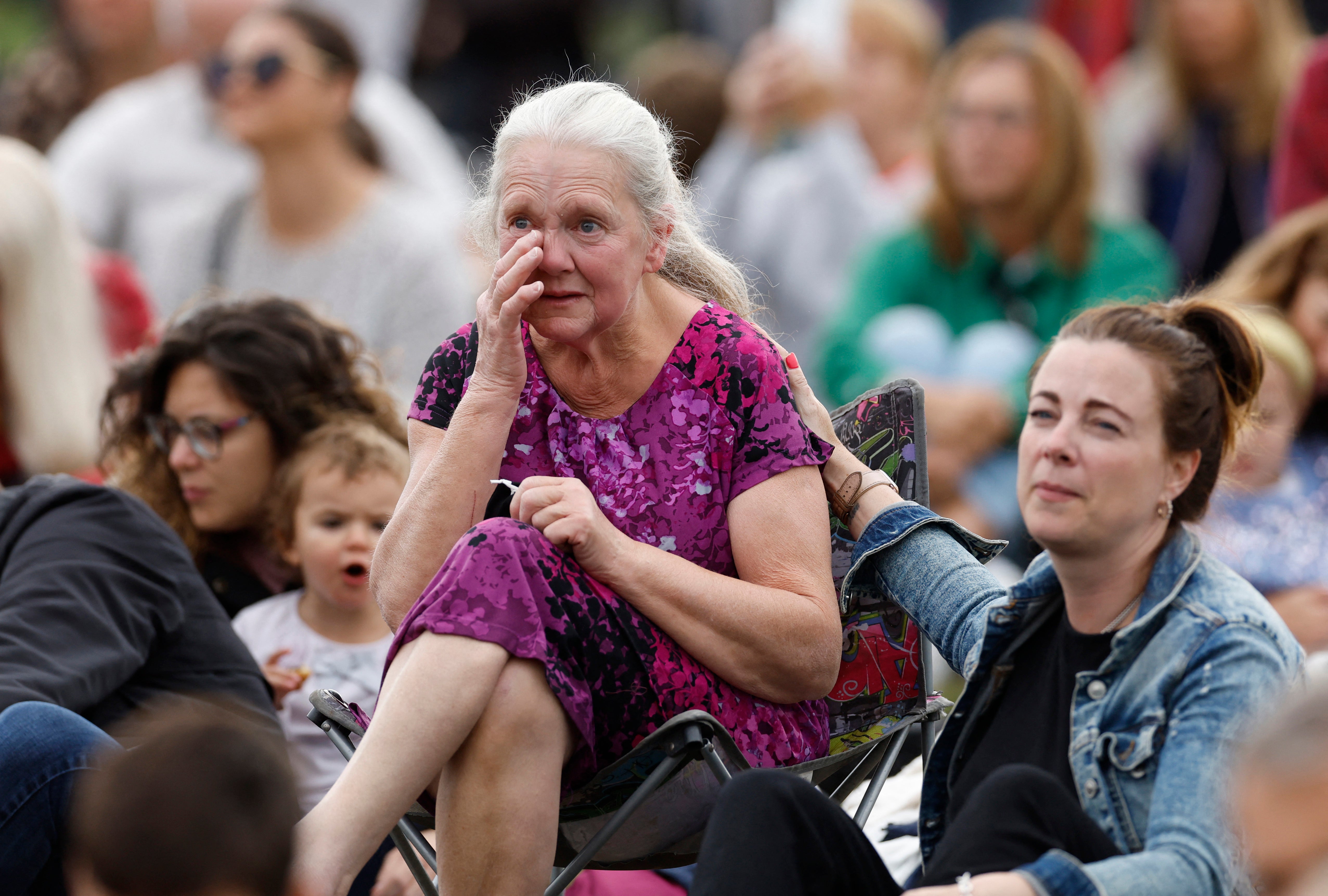 A woman cries as mourners gather in Hyde Park for the funeral