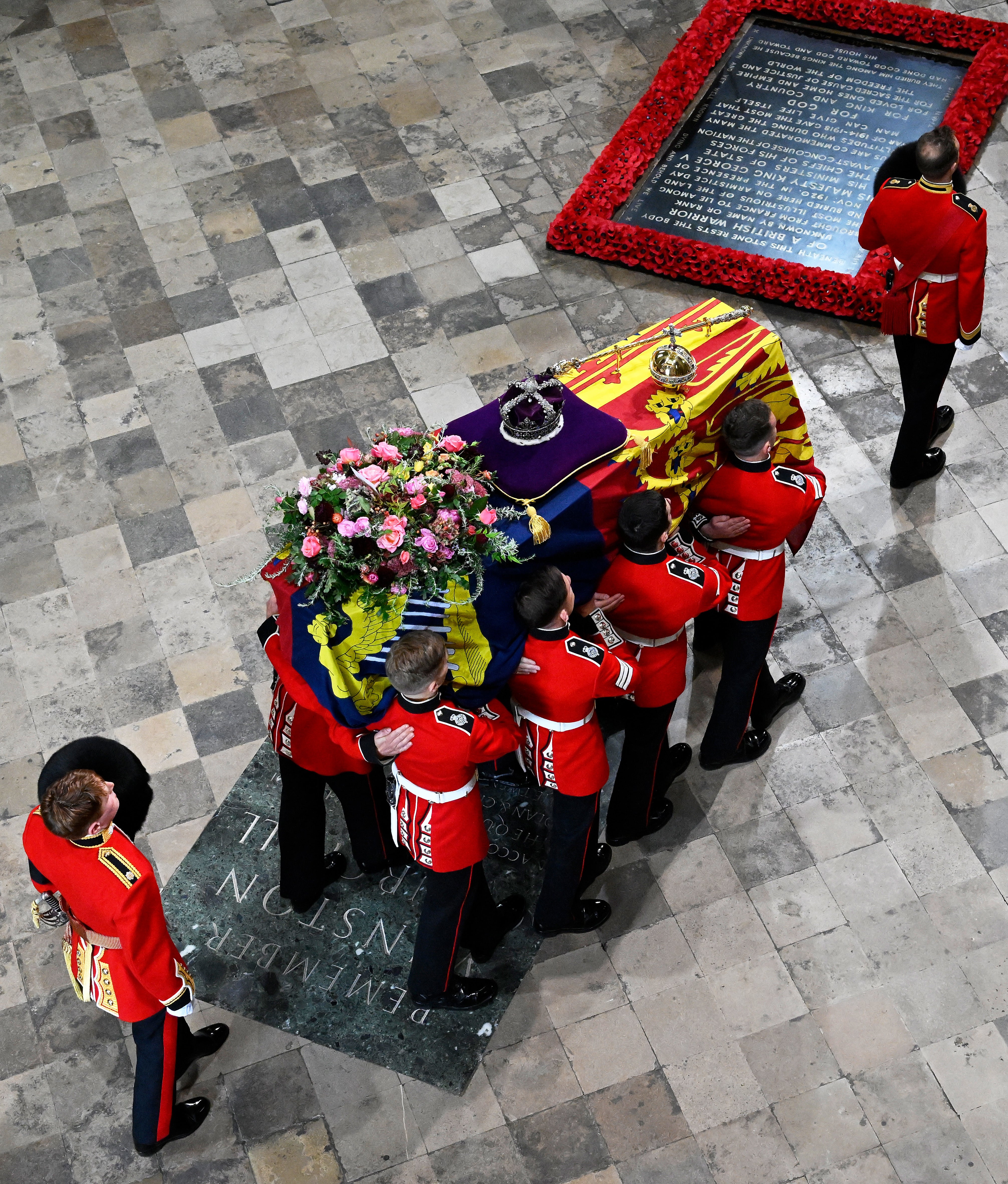 The coffin of the Queen with the Imperial State Crown resting on top is carried by the Bearer Party into Westminster Abbey (Gareth Cattermole/PA)