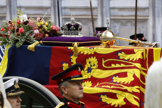 The coffin of the Queen draped in the Royal Standard with the Imperial State Crown and the Sovereign’s orb and sceptre (PA)