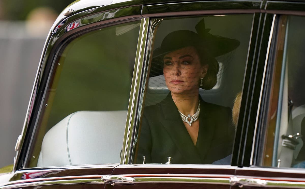 Top hats and caped detailing among garments worn by funeral guests