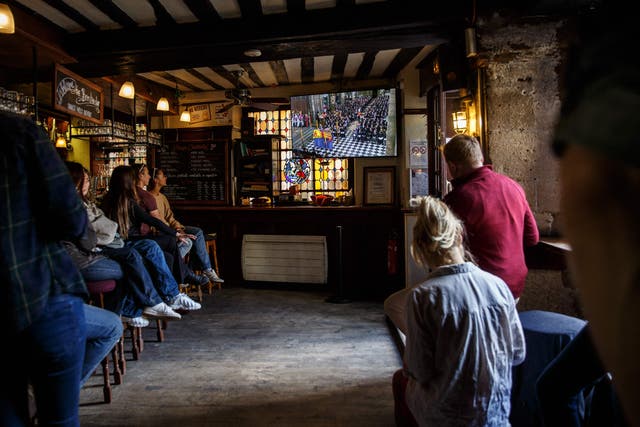 <p>Customers watch the broadcast of Queen Elizabeth II’s funeral at the Bombardier bar, an English bar in the Place de l’Odeon in Paris</p>