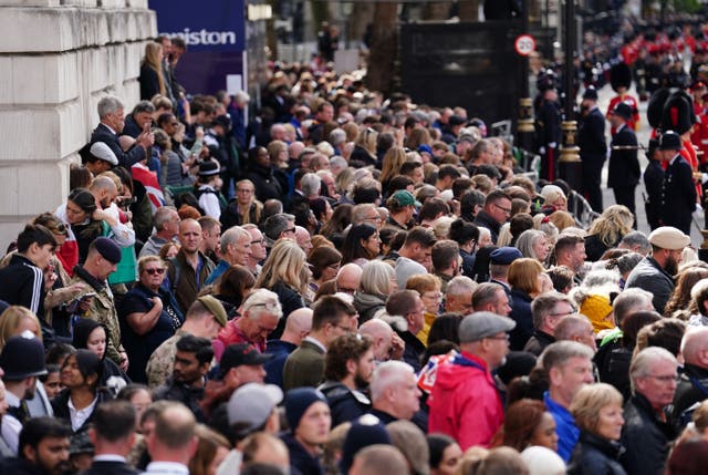Crowds listen to the service on Horse Guards Avenue during the State Funeral of Queen Elizabeth II. Picture date: Monday September 19, 2022.