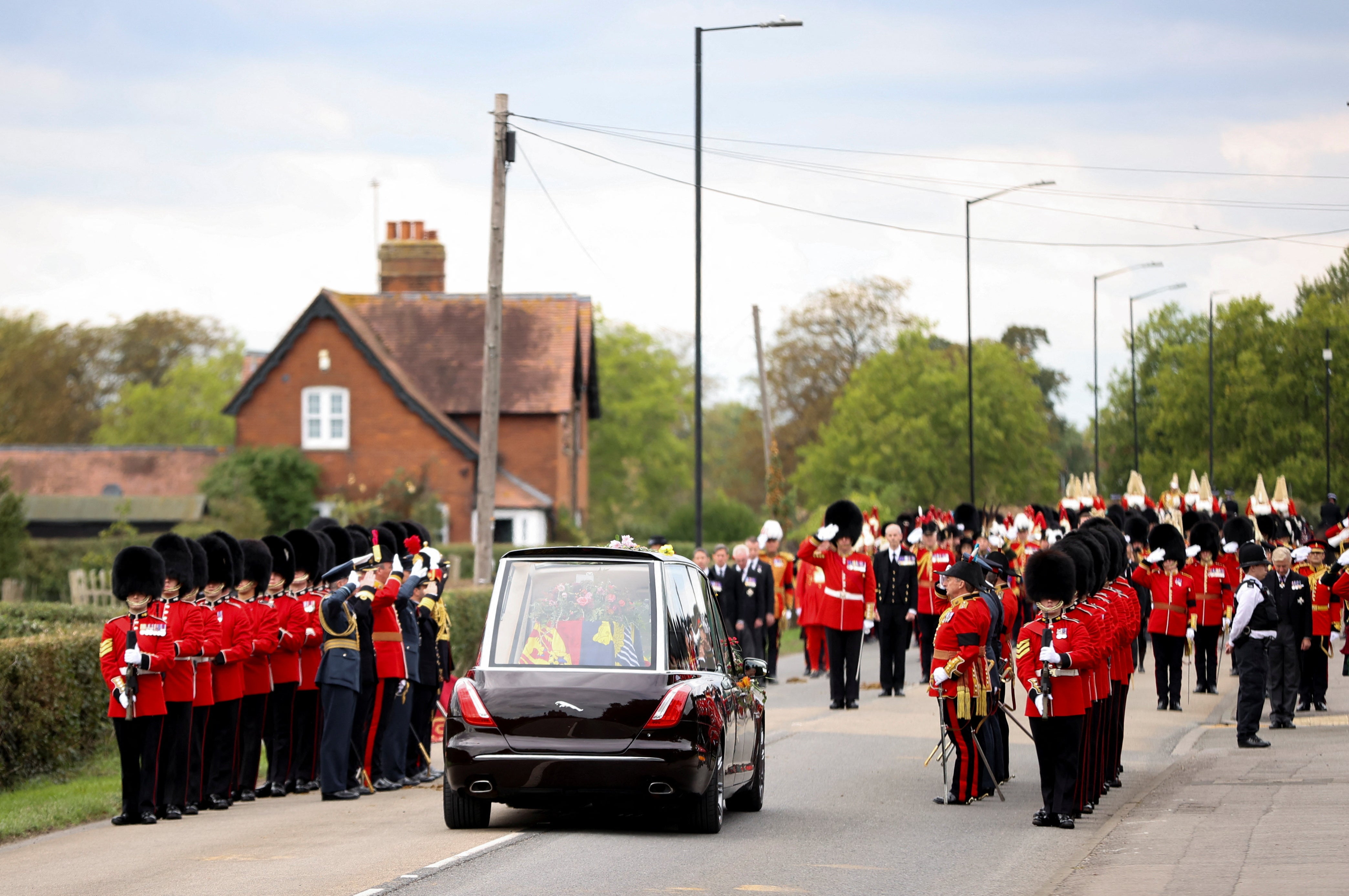 The hearse transporting the coffin of Britain's Queen Elizabeth drives near Royal Guards along Albert Road on the day of her state funeral and burial