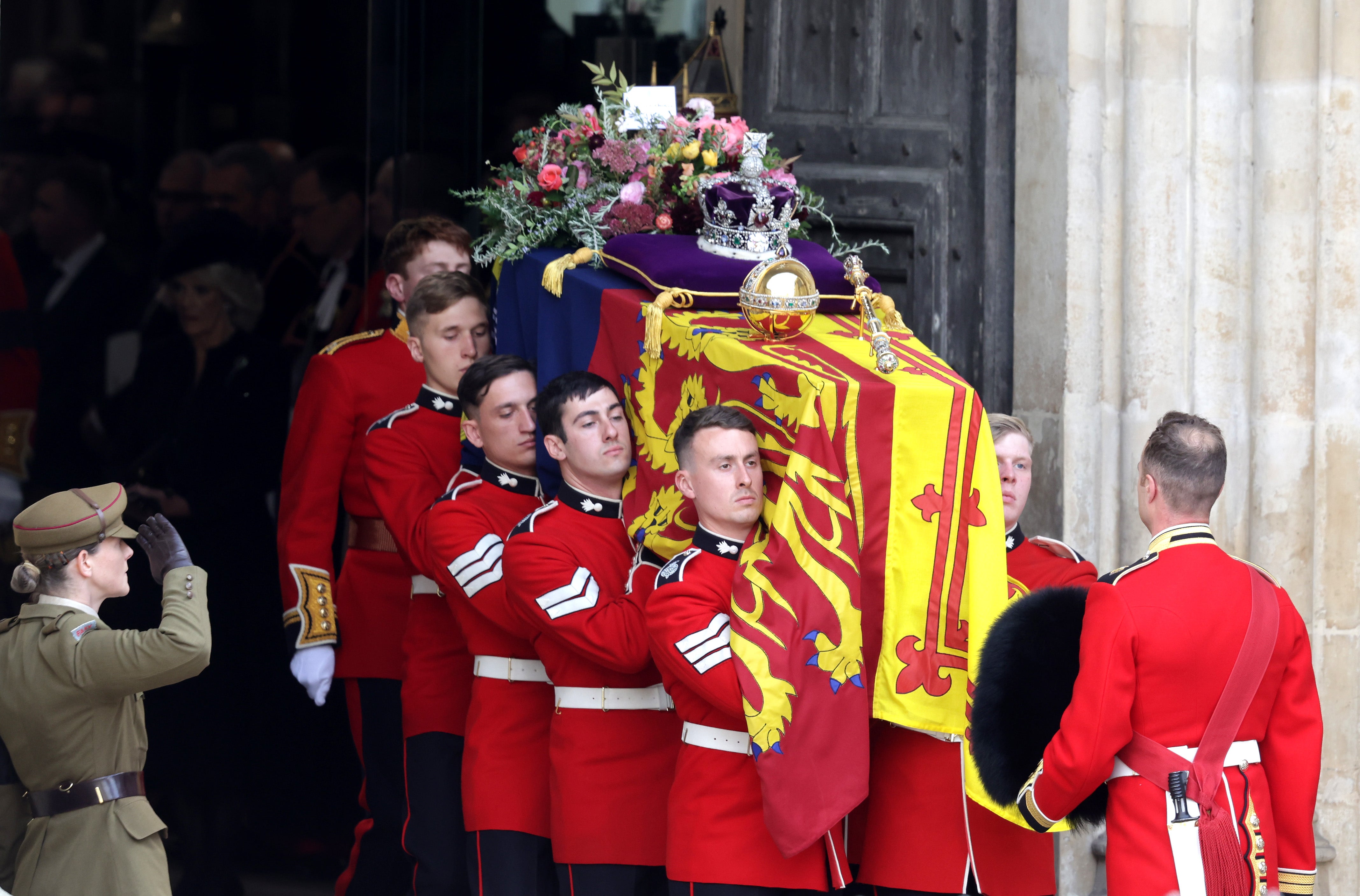 HM Queen Elizabeth’s coffin is carried out of the doors of Westminster Abbey.