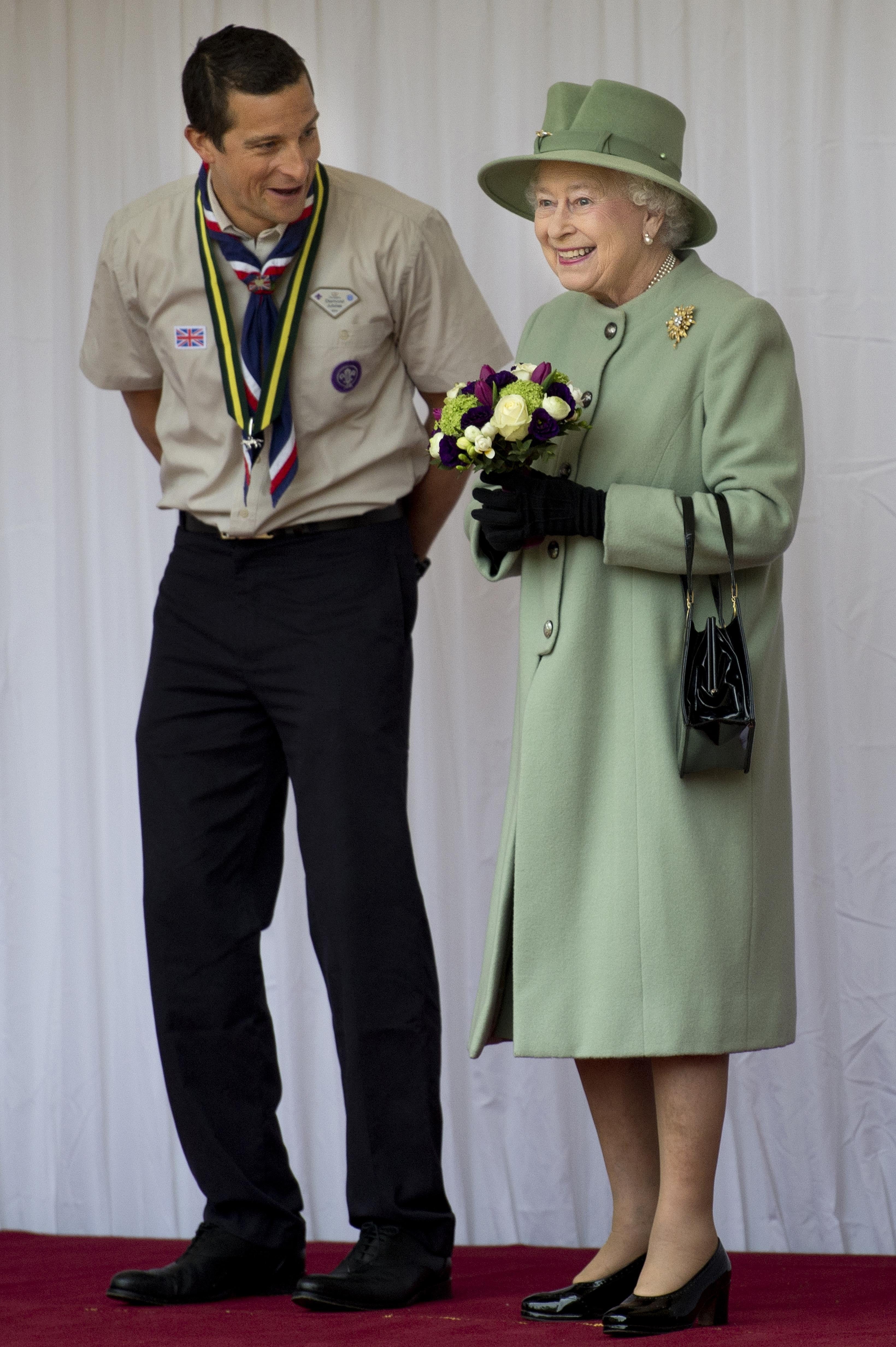 Chief Scout, Bear Grylls, left, chats with the Queen during a review of the Queen’s Scouts at Windsor Castle, in Berkshire (Ben Stansall/PA)